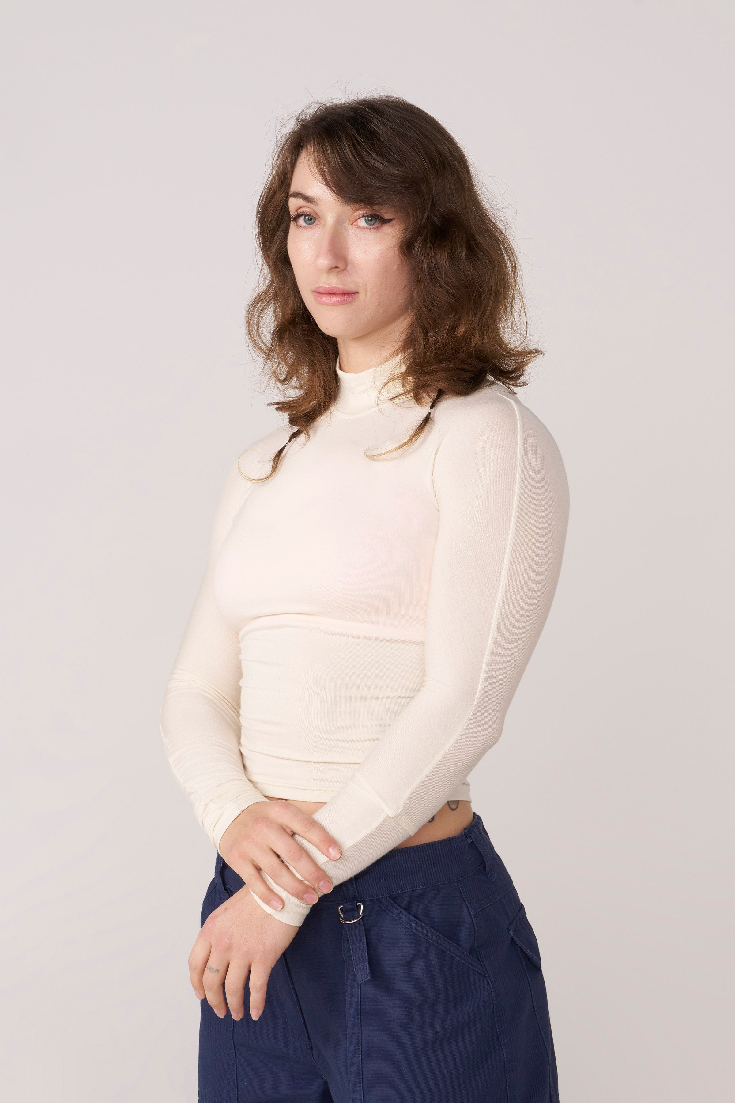 Front view of the sleek sheer long sleeve crop top on a model.