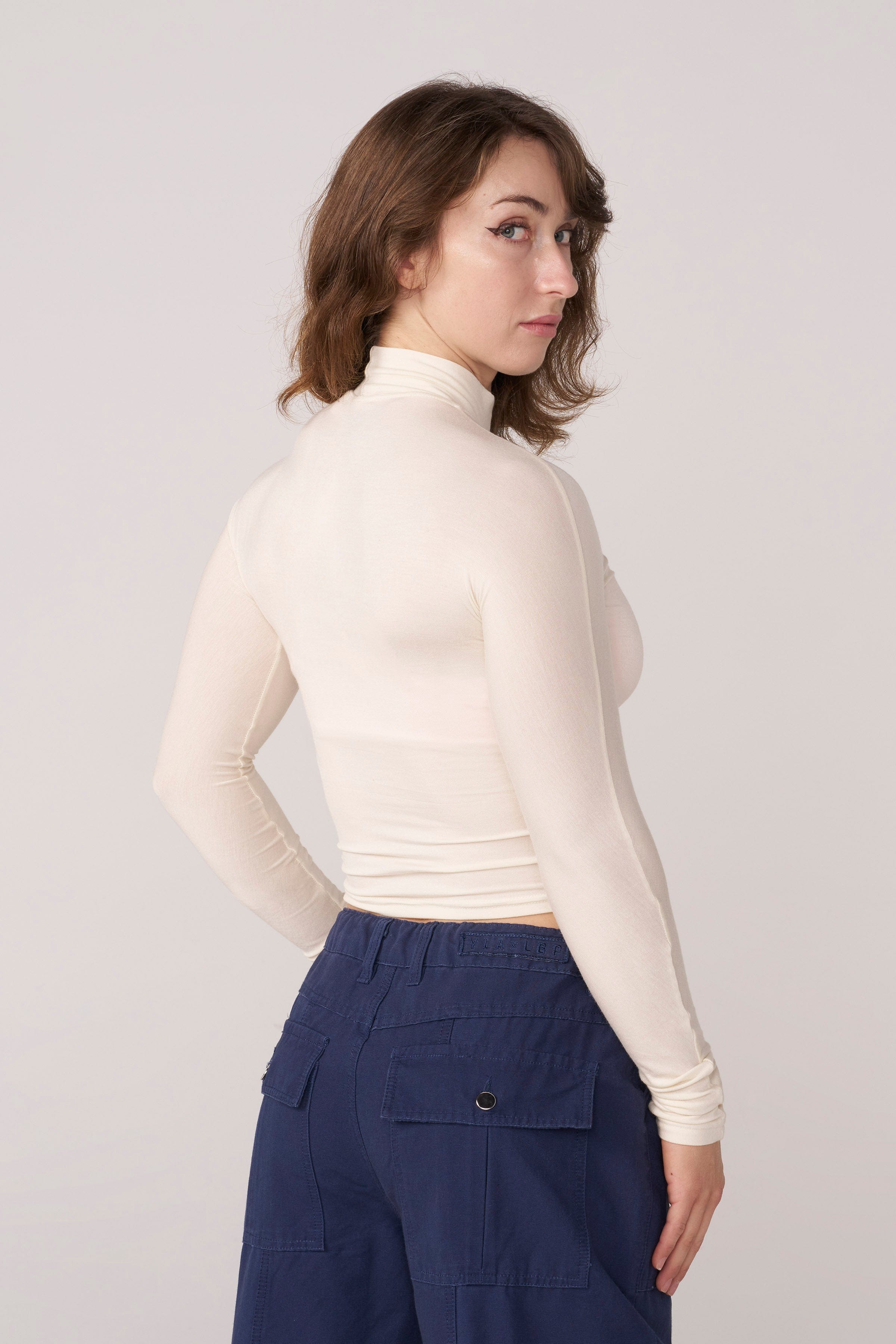 Close-up of the fabric texture of the sheer long sleeve top.