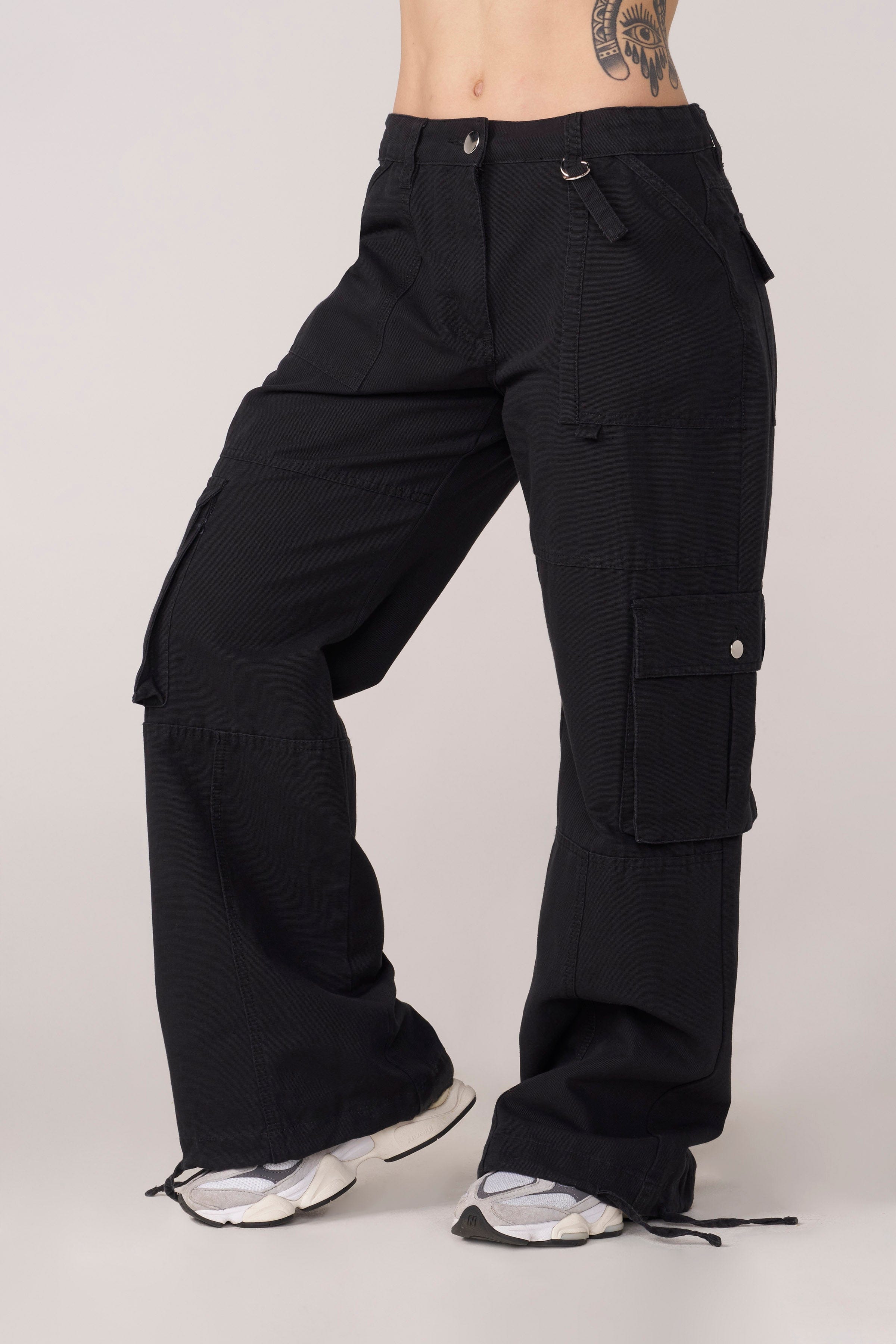 Model pairing cargos with streetwear hoodies for casual urban look
