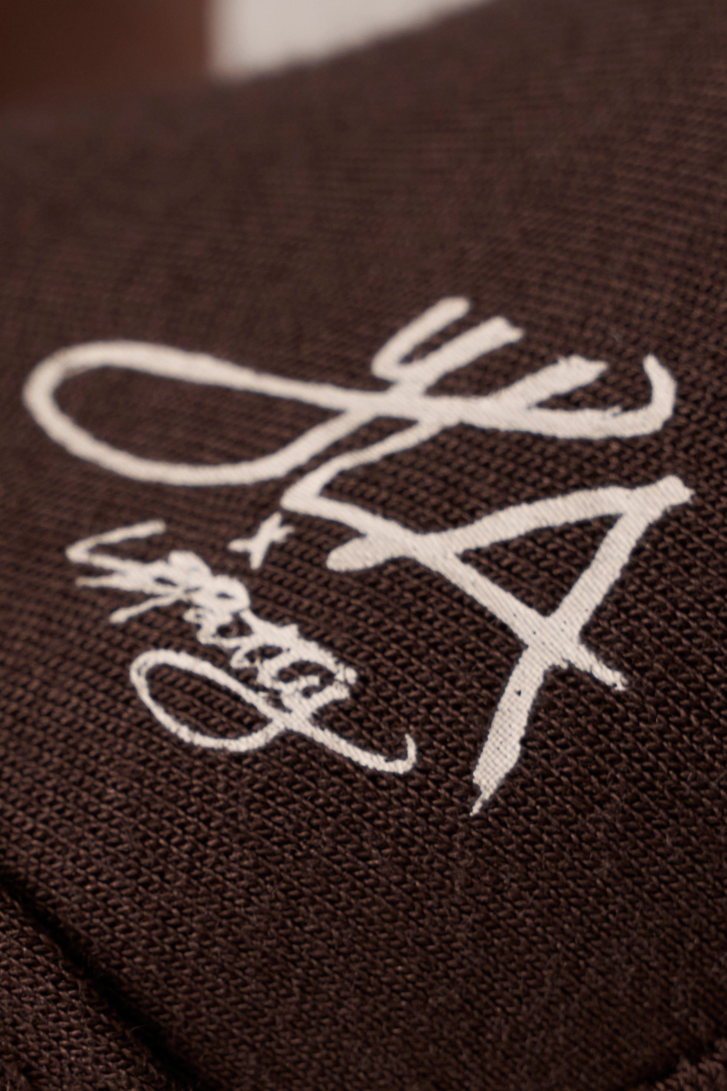 Close-up of the fabric texture of the sheer long sleeve top.