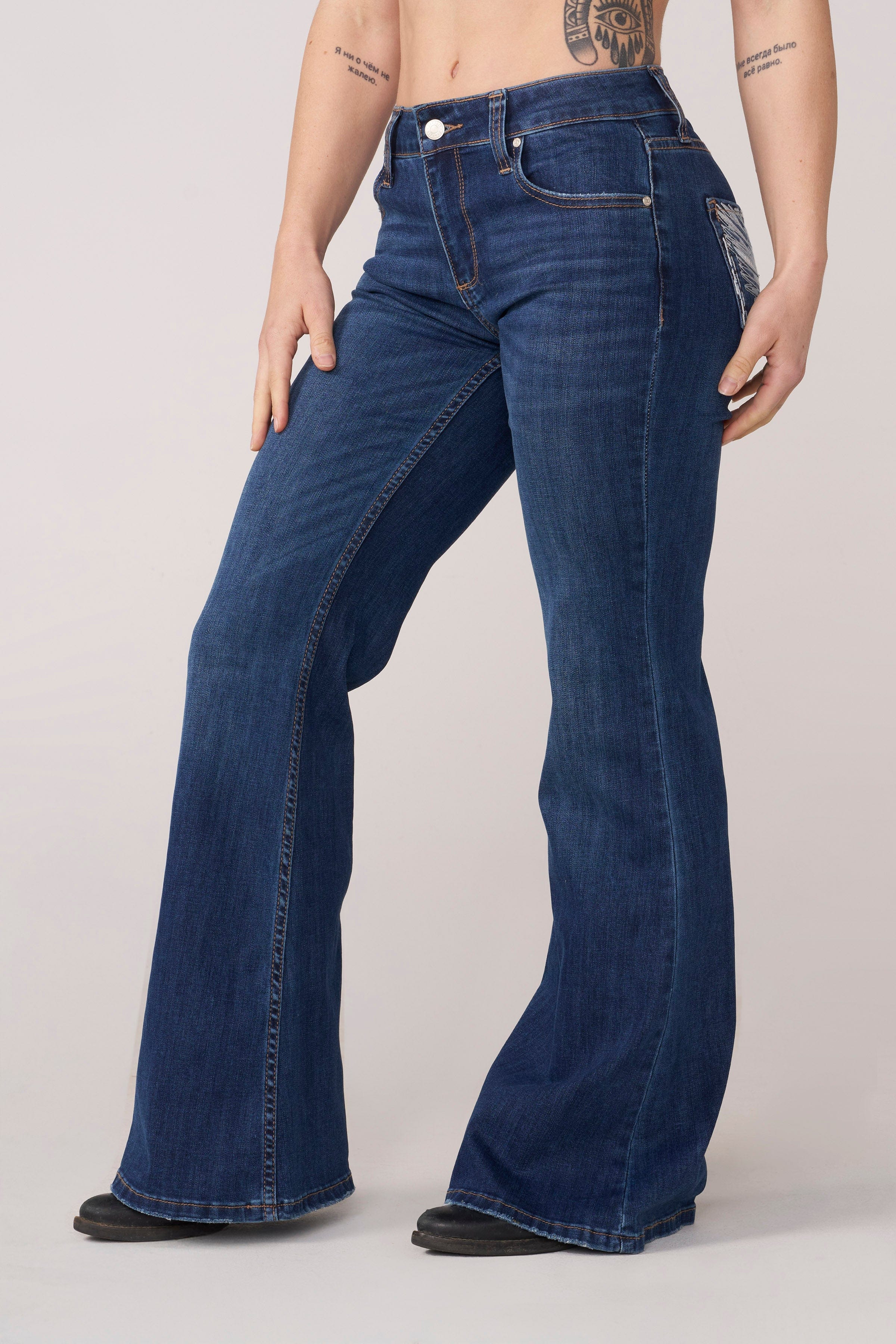 Close-up of the wing-inspired details on the flare jeans.