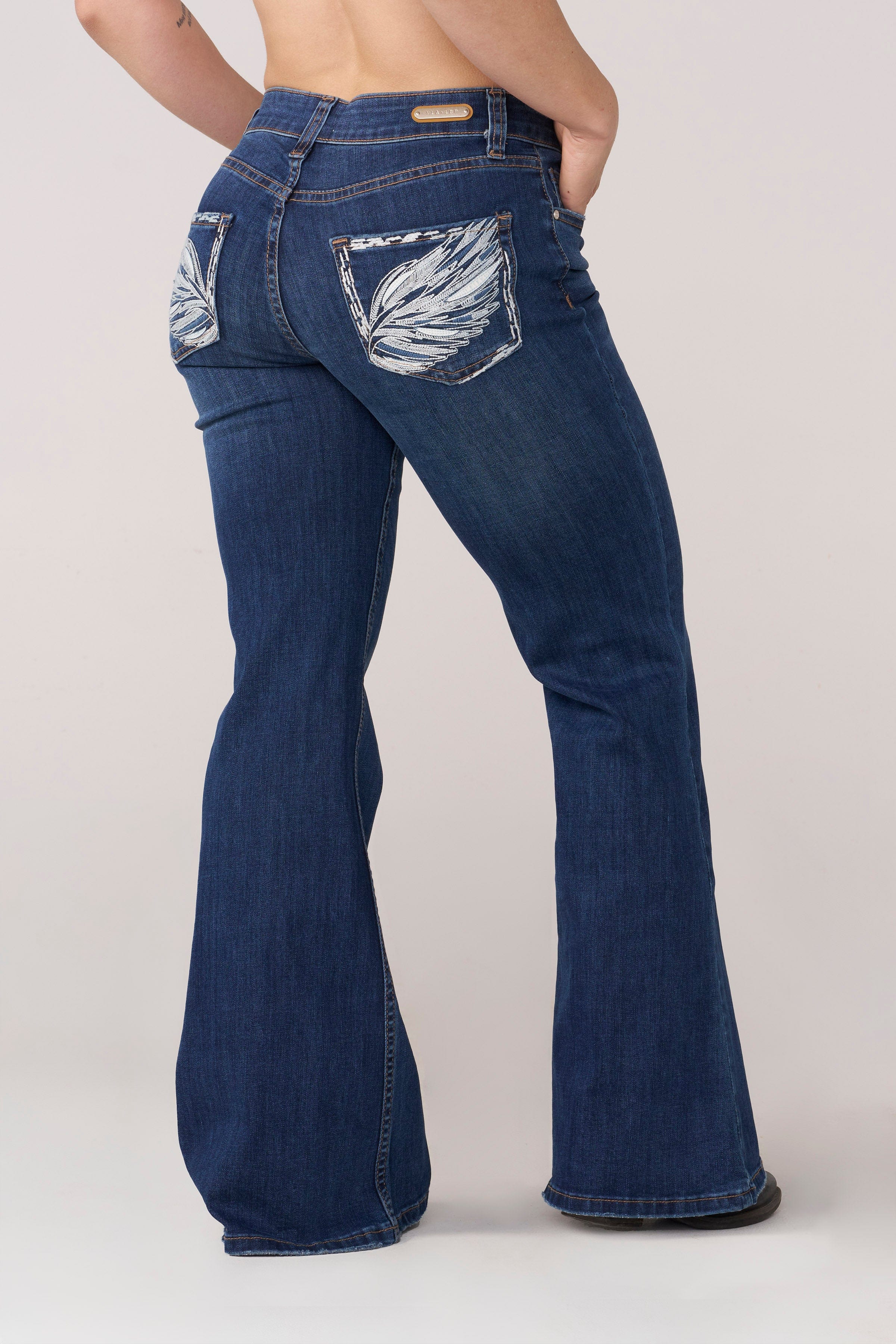 Close-up of the wing-inspired details on the flare jeans.