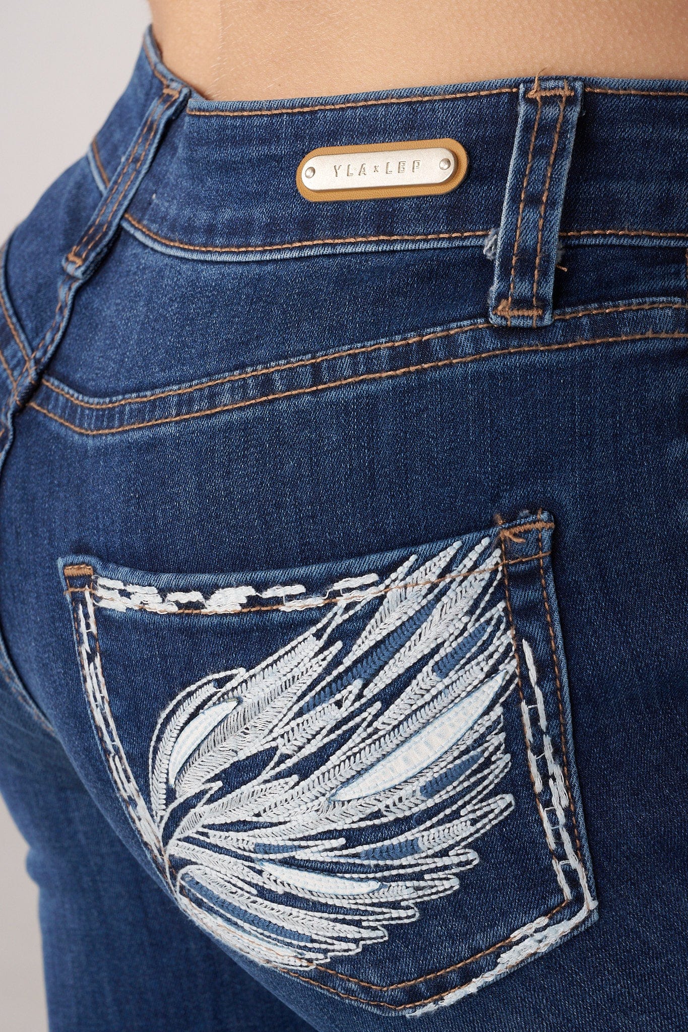Front view of a model in sculpting high-waist flare jeans.