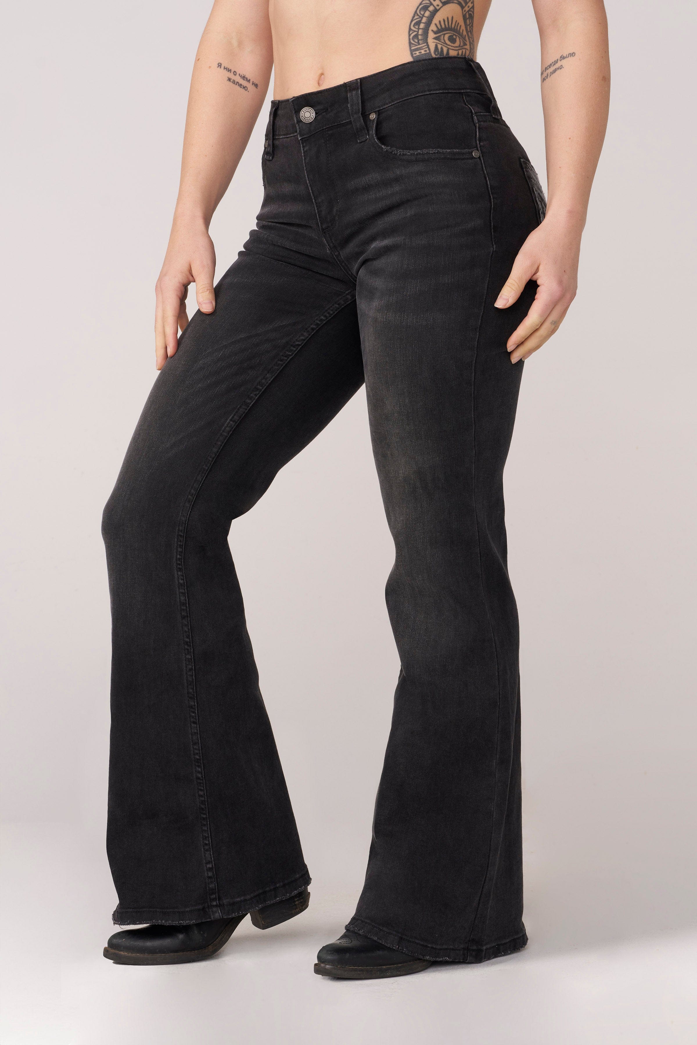 Front view of a model in sculpting high-waist flare jeans.