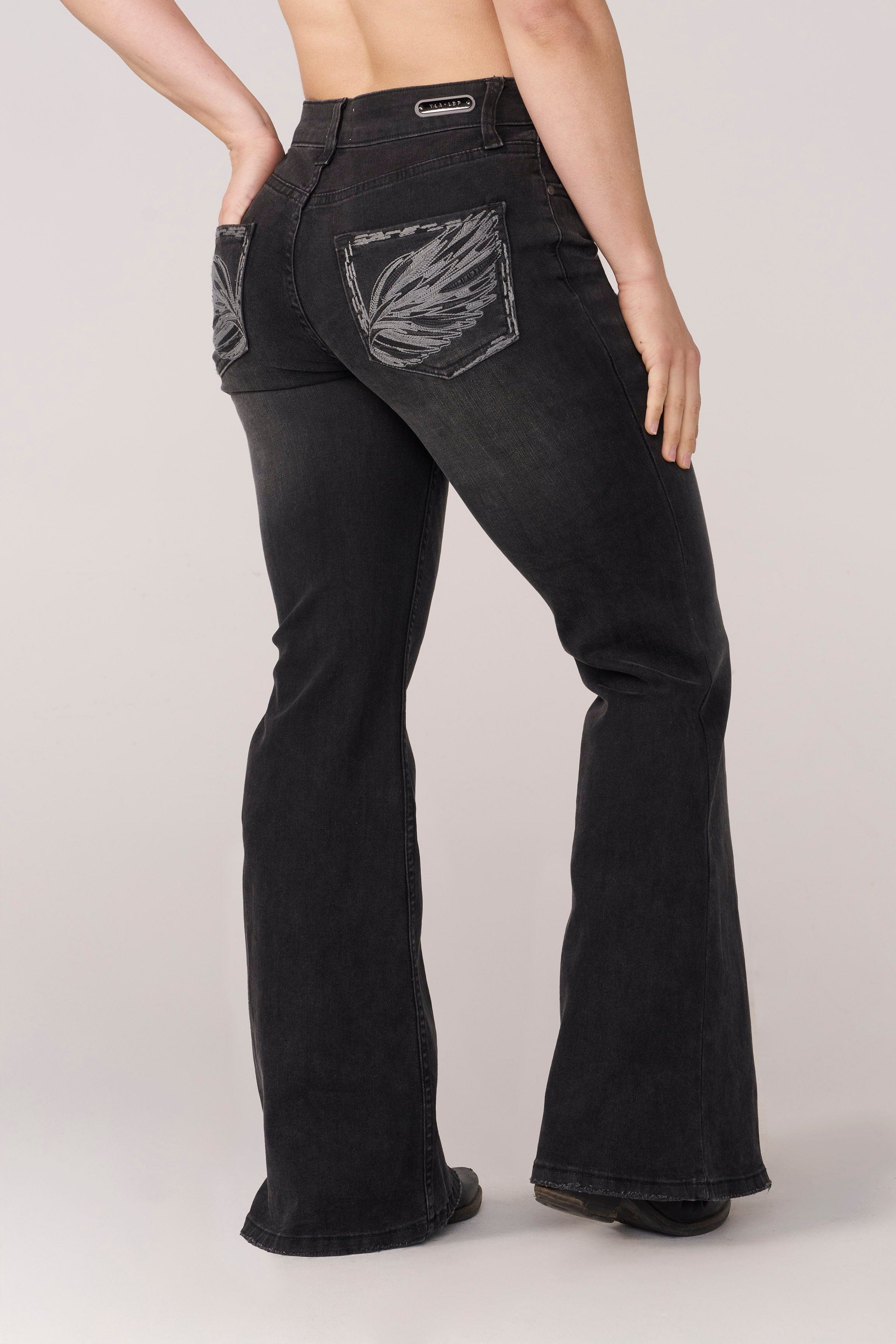 Side view highlighting the fit and flare of the jeans.