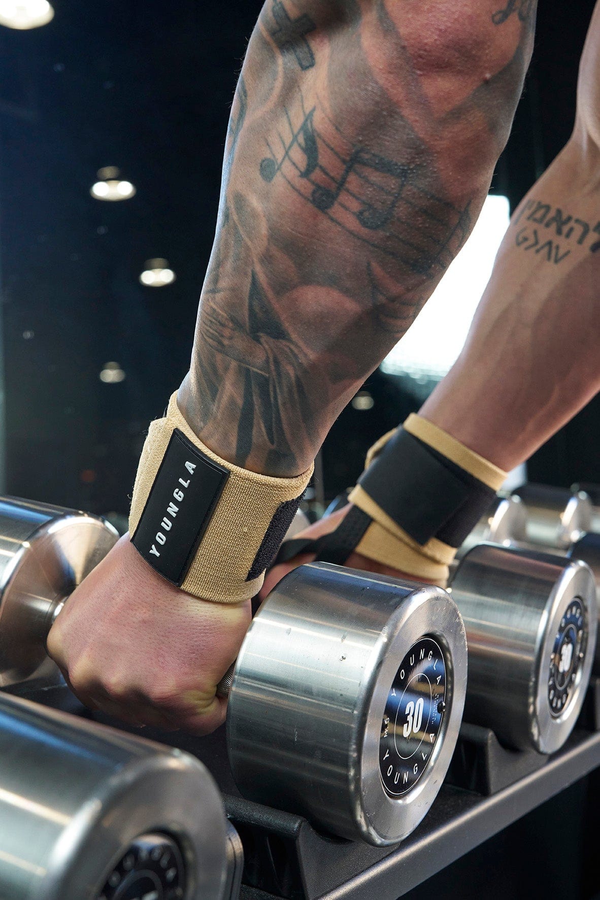 Detail shot of lifting straps and wrist wraps resting on gym bench after training.