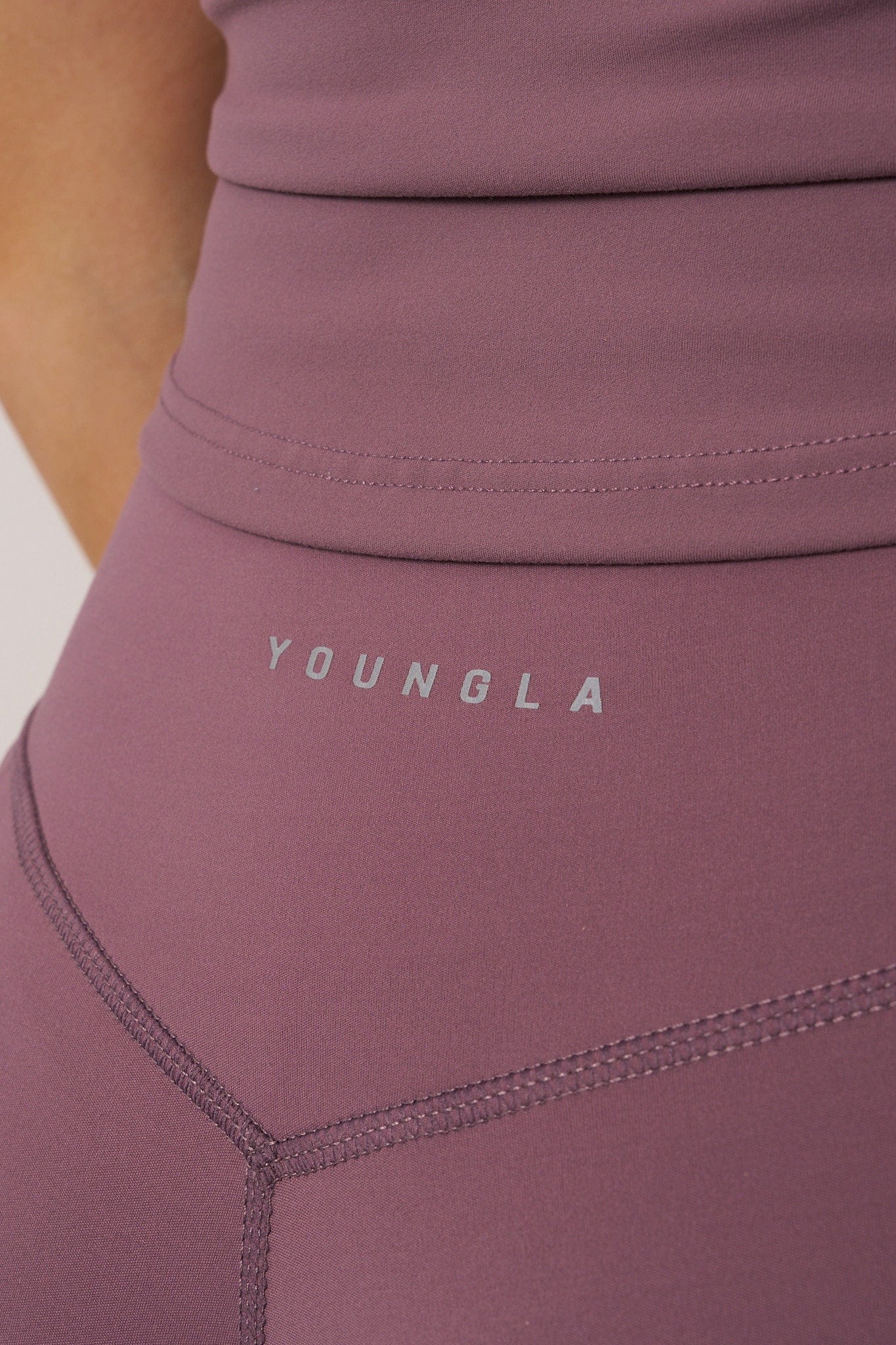 Close-up of high-waist grey flare leggings on a model