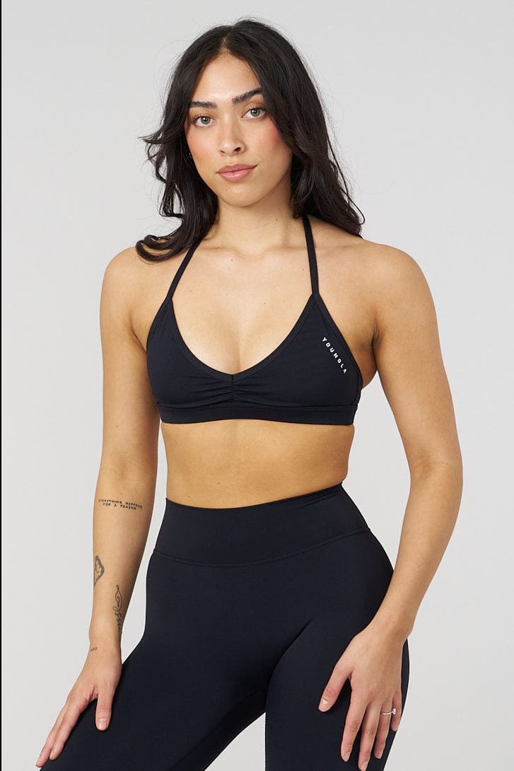 Backless design of the Urban V-Neck workout bra during exercise.