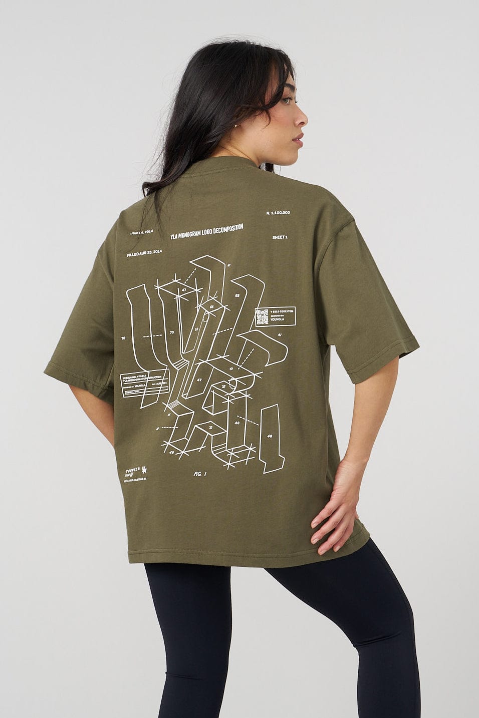 Model wearing oversized graphic tee with digital artwork in a city setting
