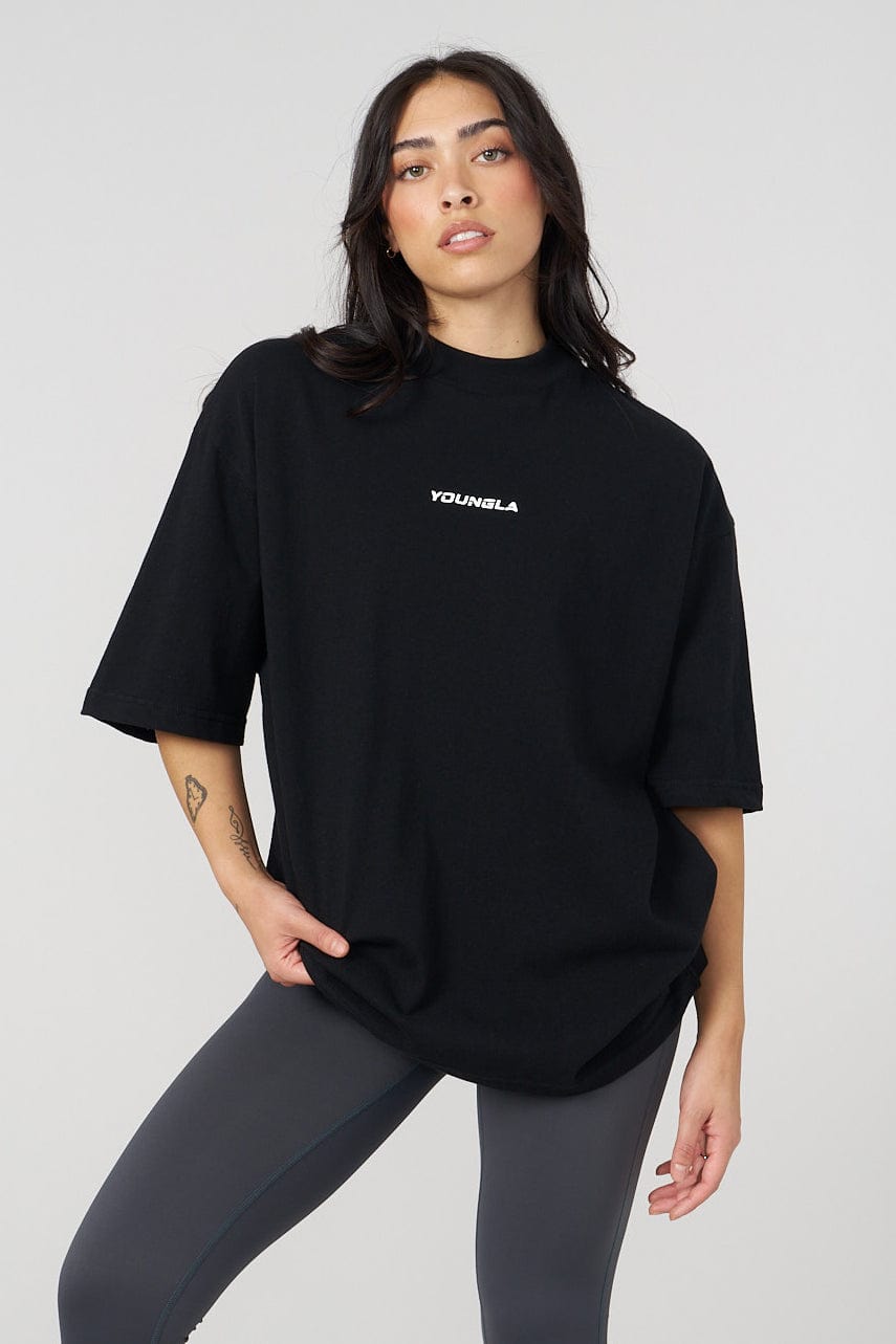 Model wearing oversized graphic tee with digital artwork in a city setting