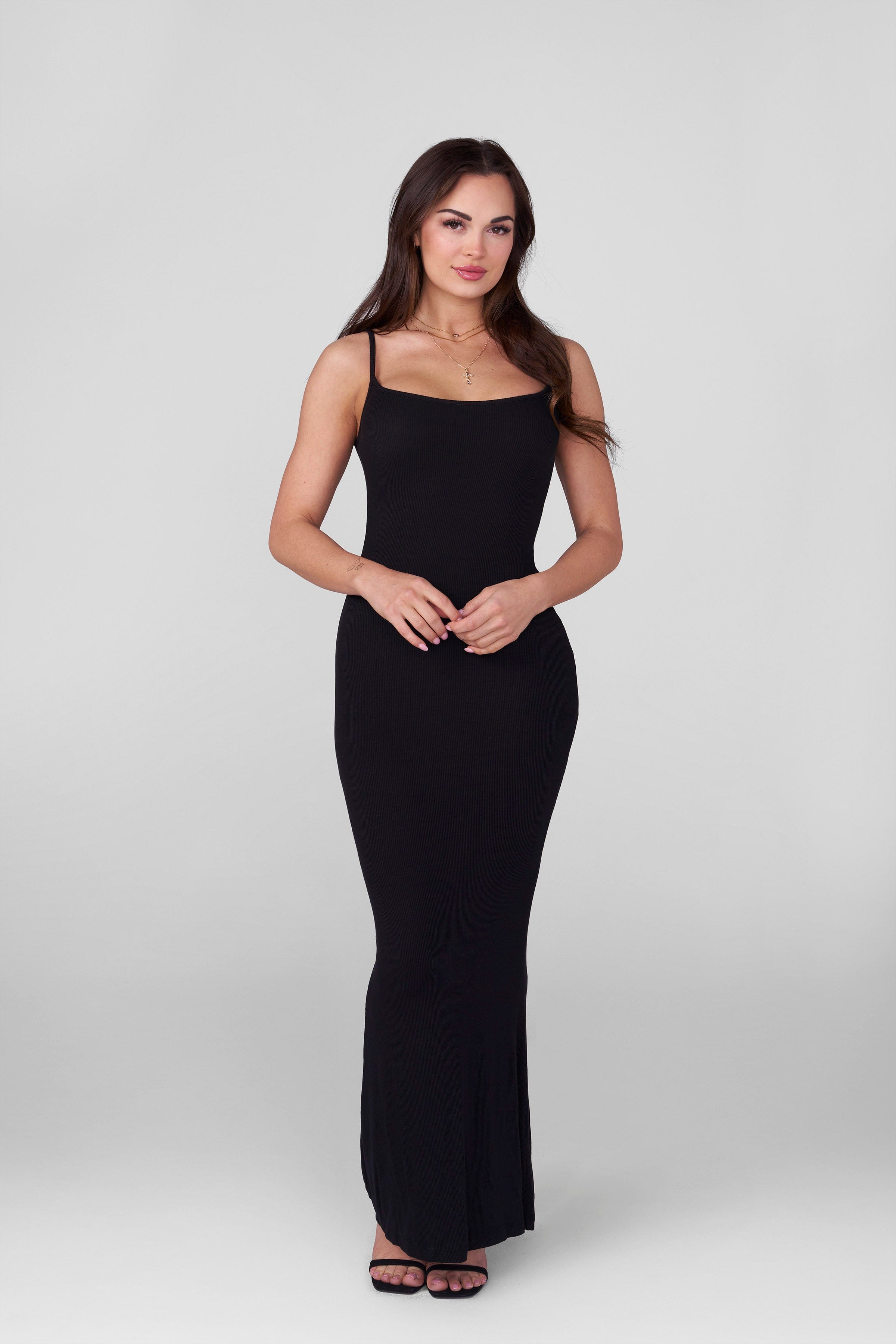 Black bodycon slip dress worn by model for night out
