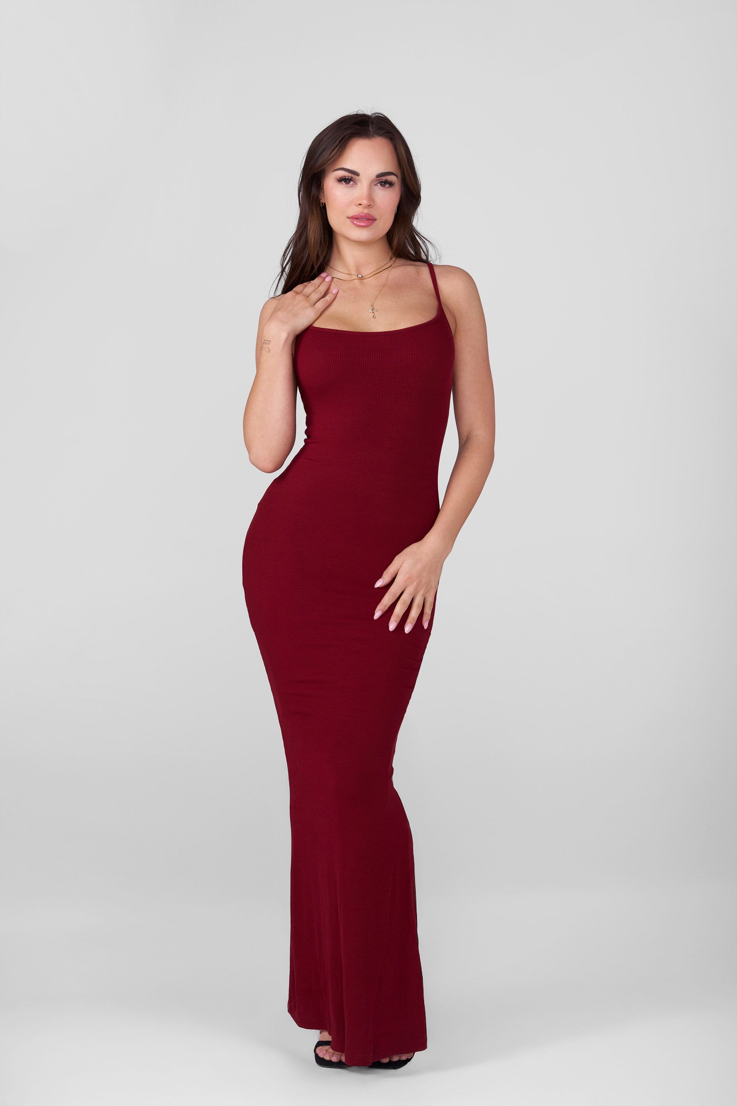 Black bodycon slip dress worn by model for night out