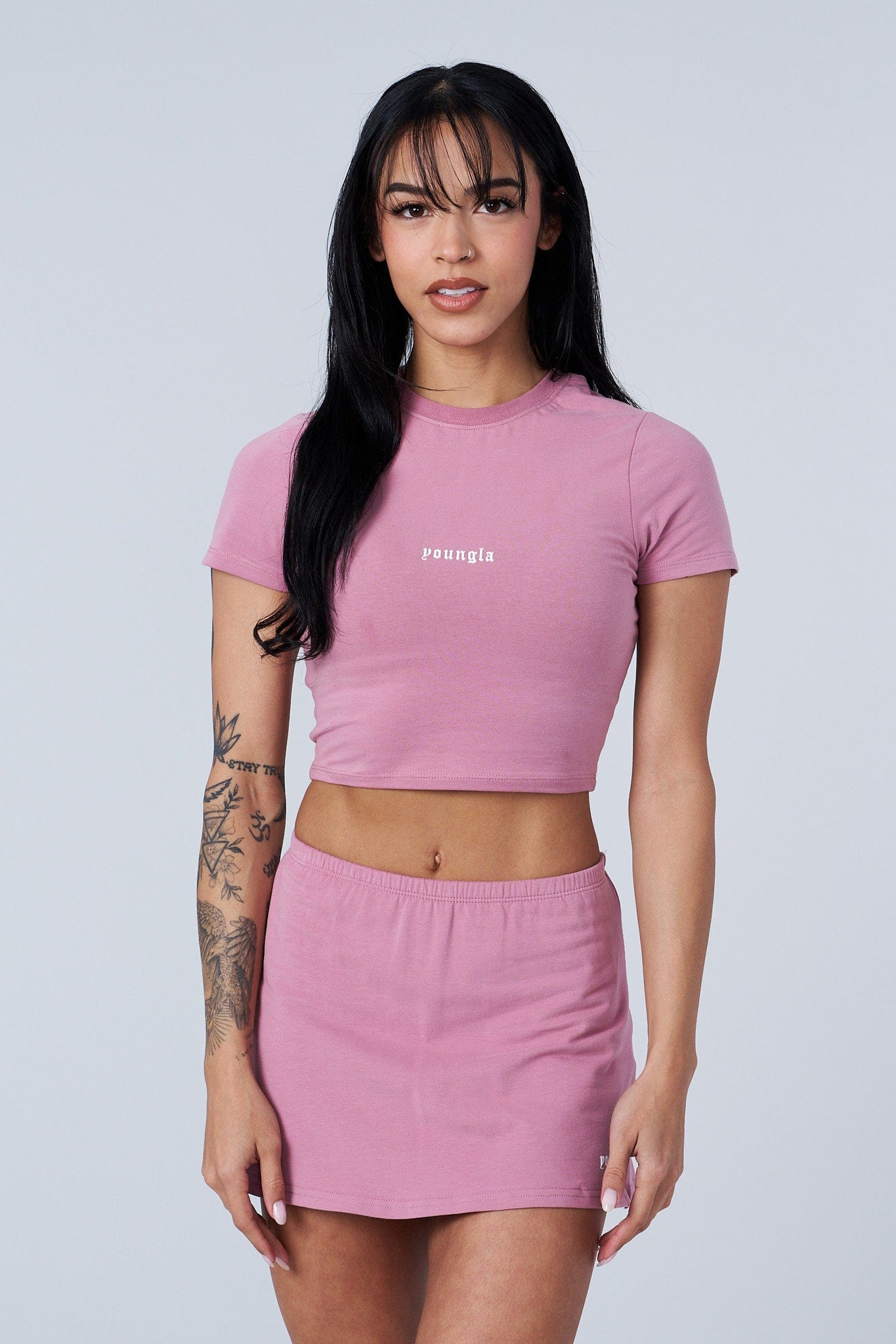 Model wearing the baby tee with stylish shorts for a casual look.