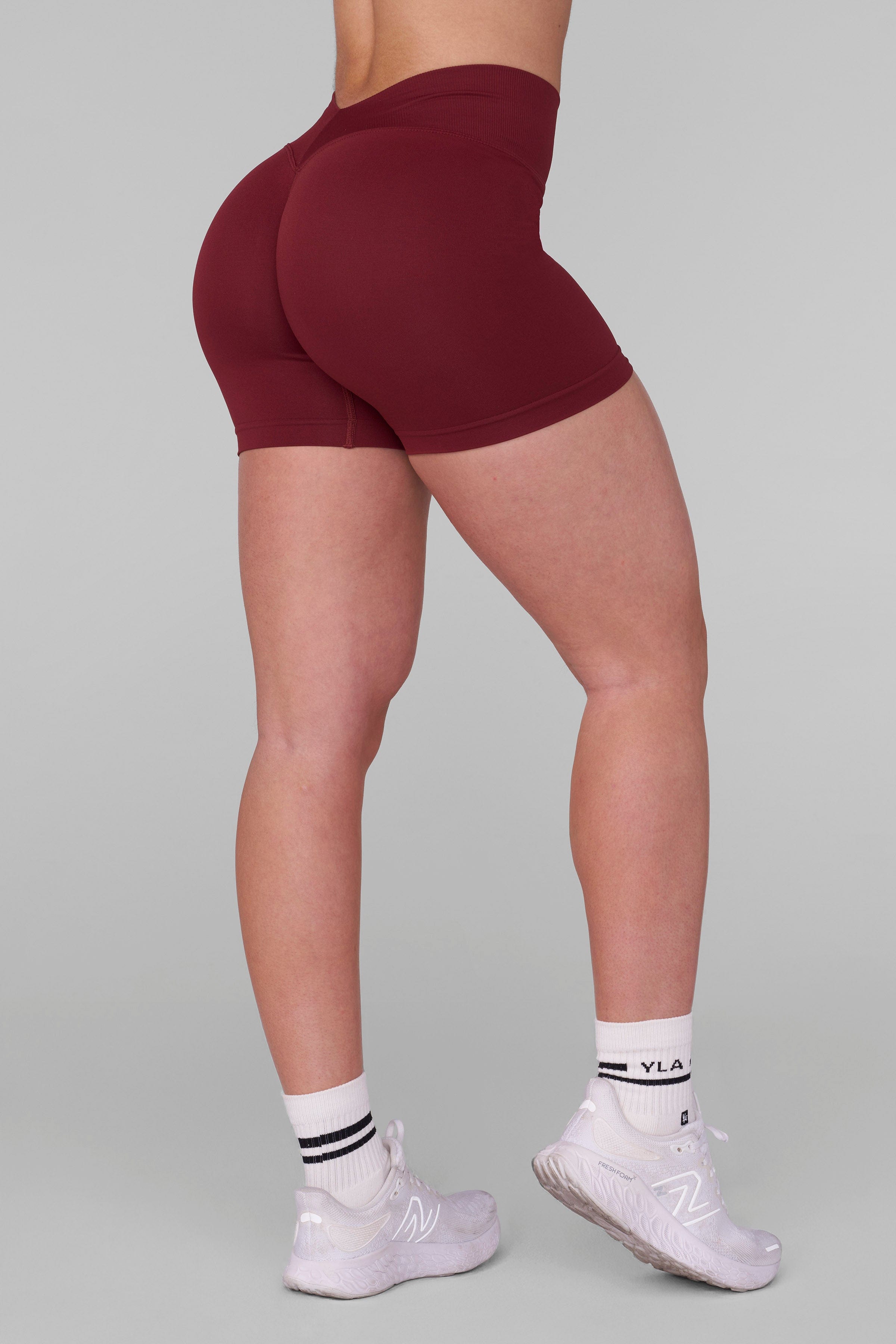 Side view of women wearing SculptLift gym shorts during a fitness session.