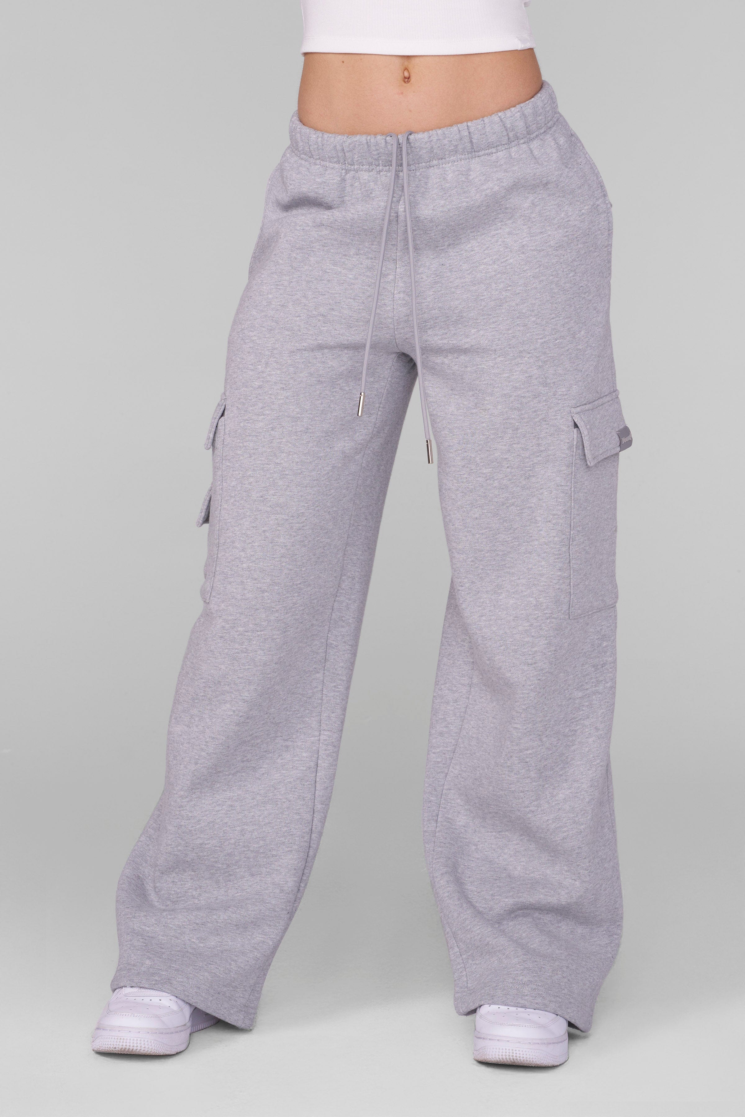 Front view of black joggers with oversized fit and cargo pockets worn by model