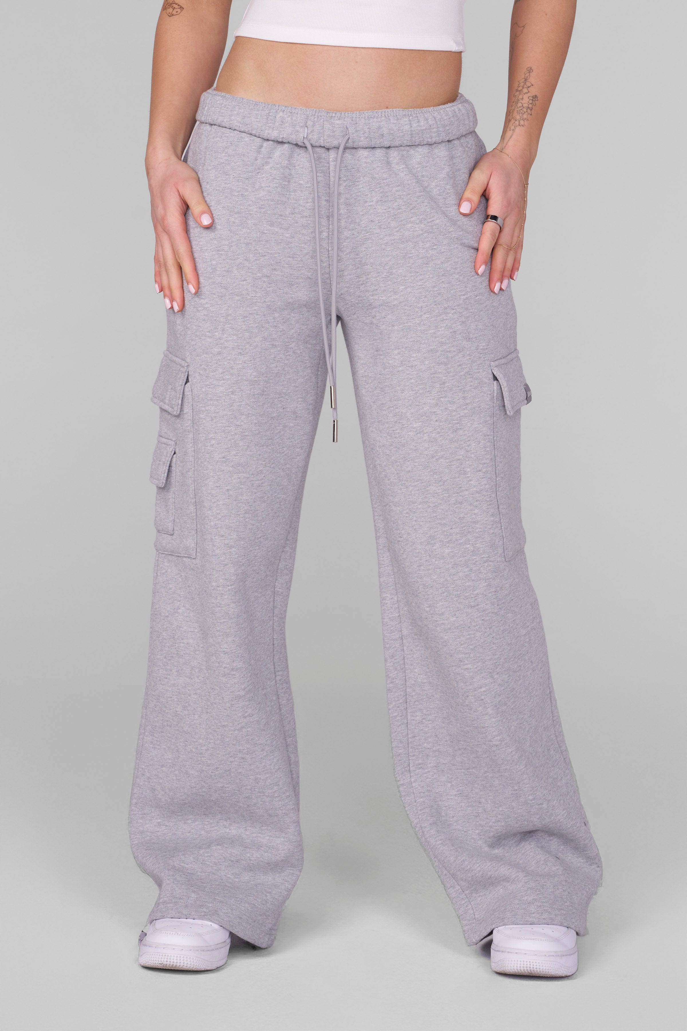 Front view of black joggers with oversized fit and cargo pockets worn by model