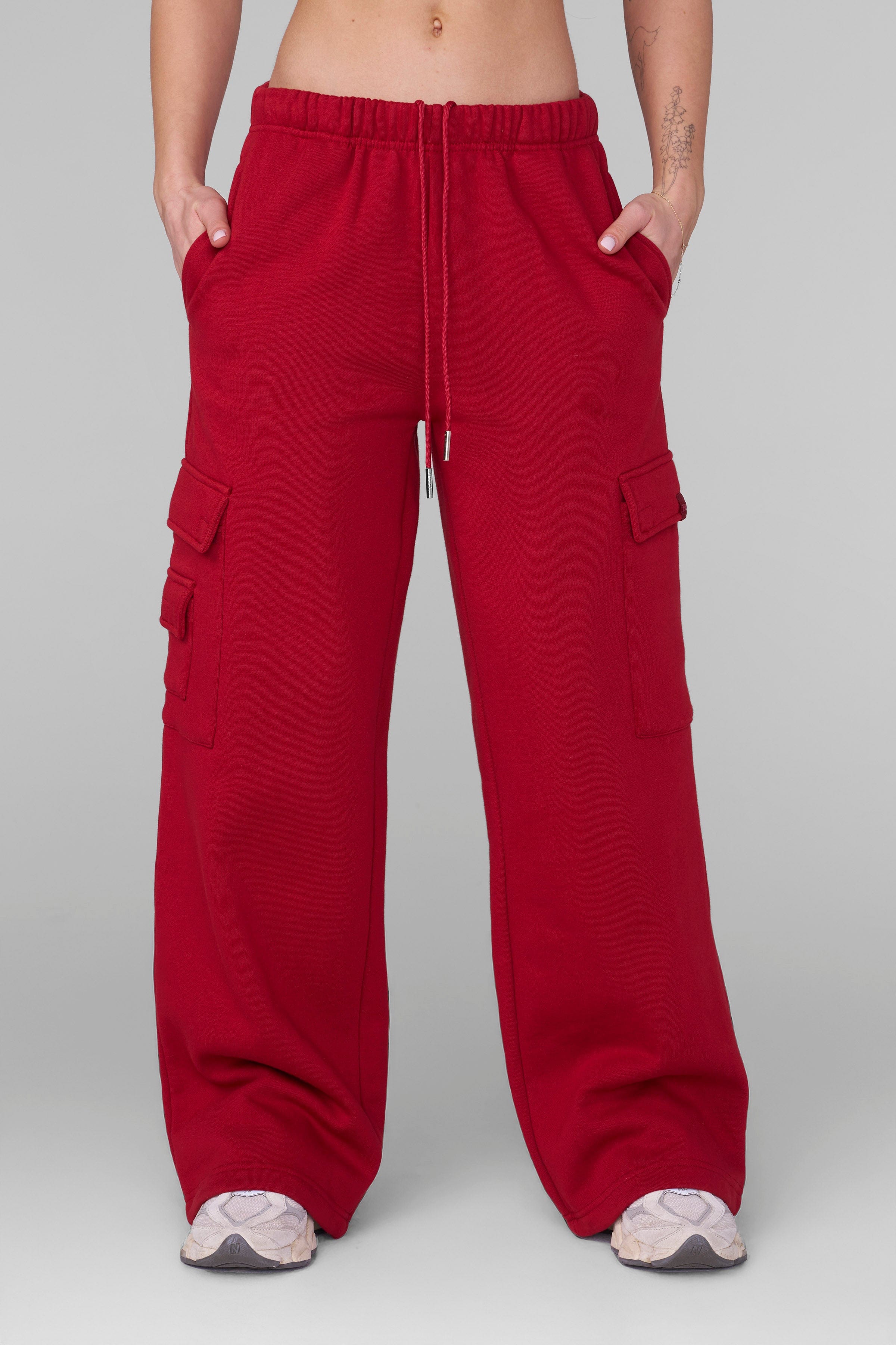 Front view of black joggers with oversized fit and cargo pockets worn by model