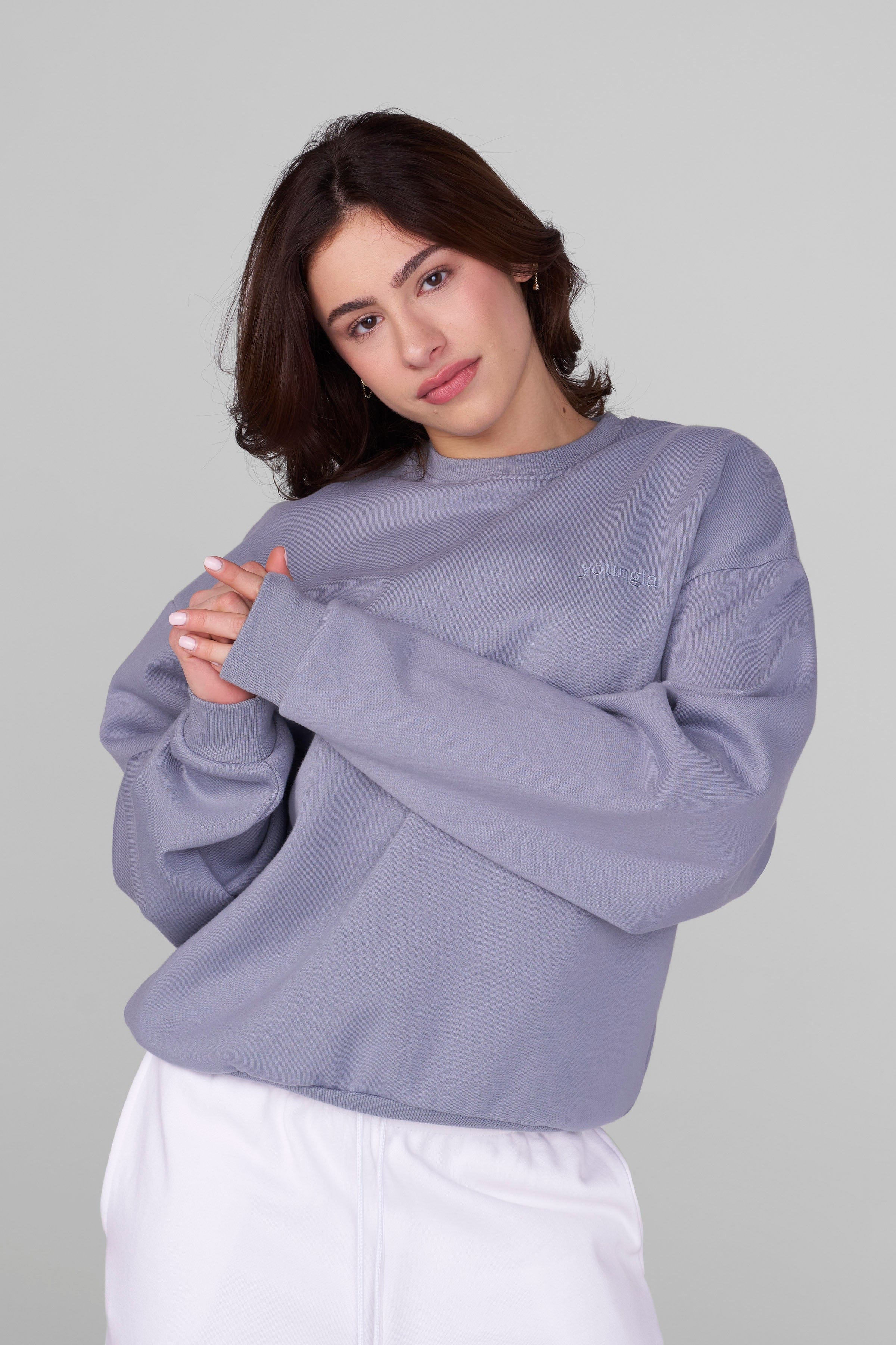 Side angle showing relaxed fit of hanes f260 ultimate cotton crewneck sweatshirt worn outdoors