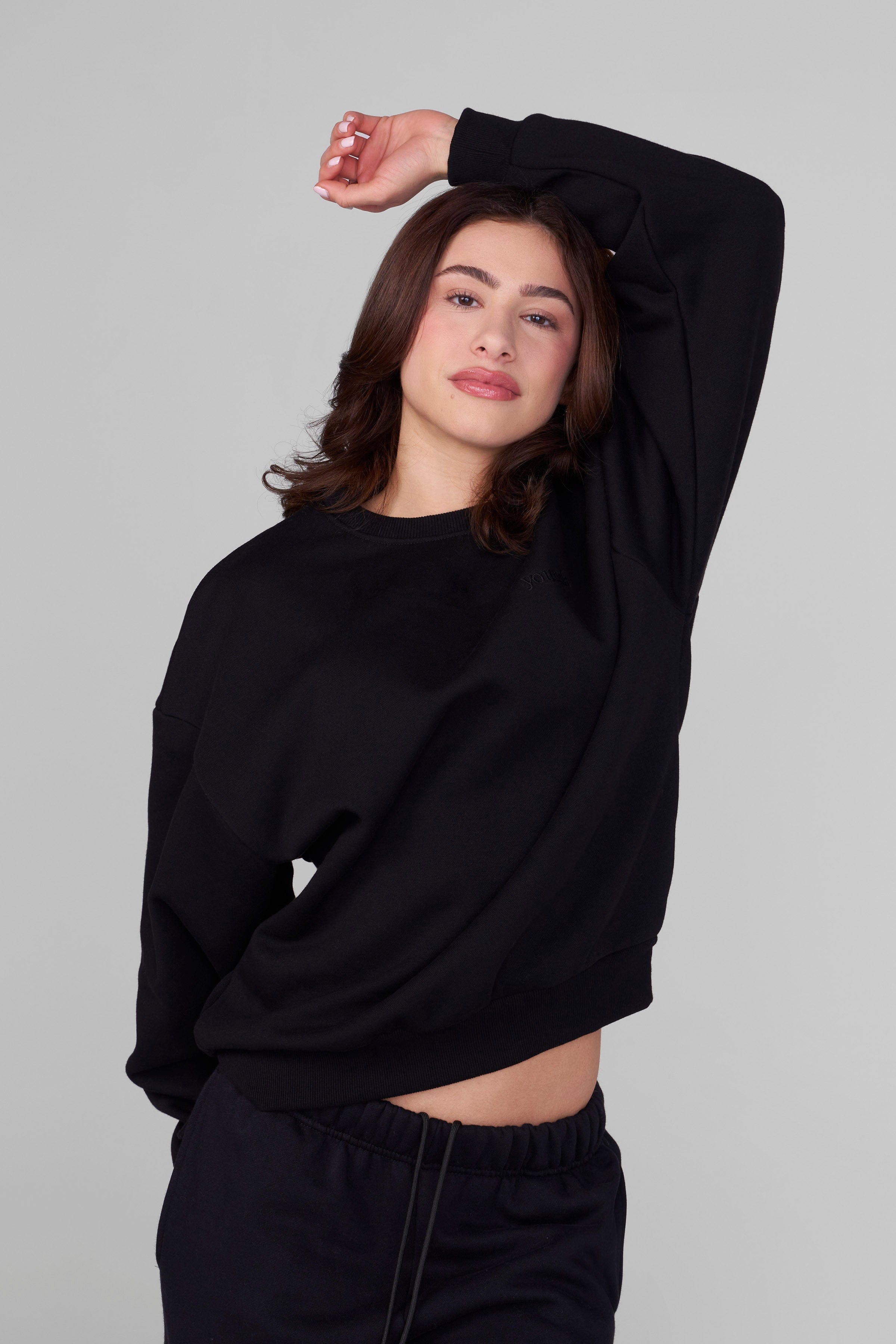 Side angle showing relaxed fit of hanes f260 ultimate cotton crewneck sweatshirt worn outdoors
