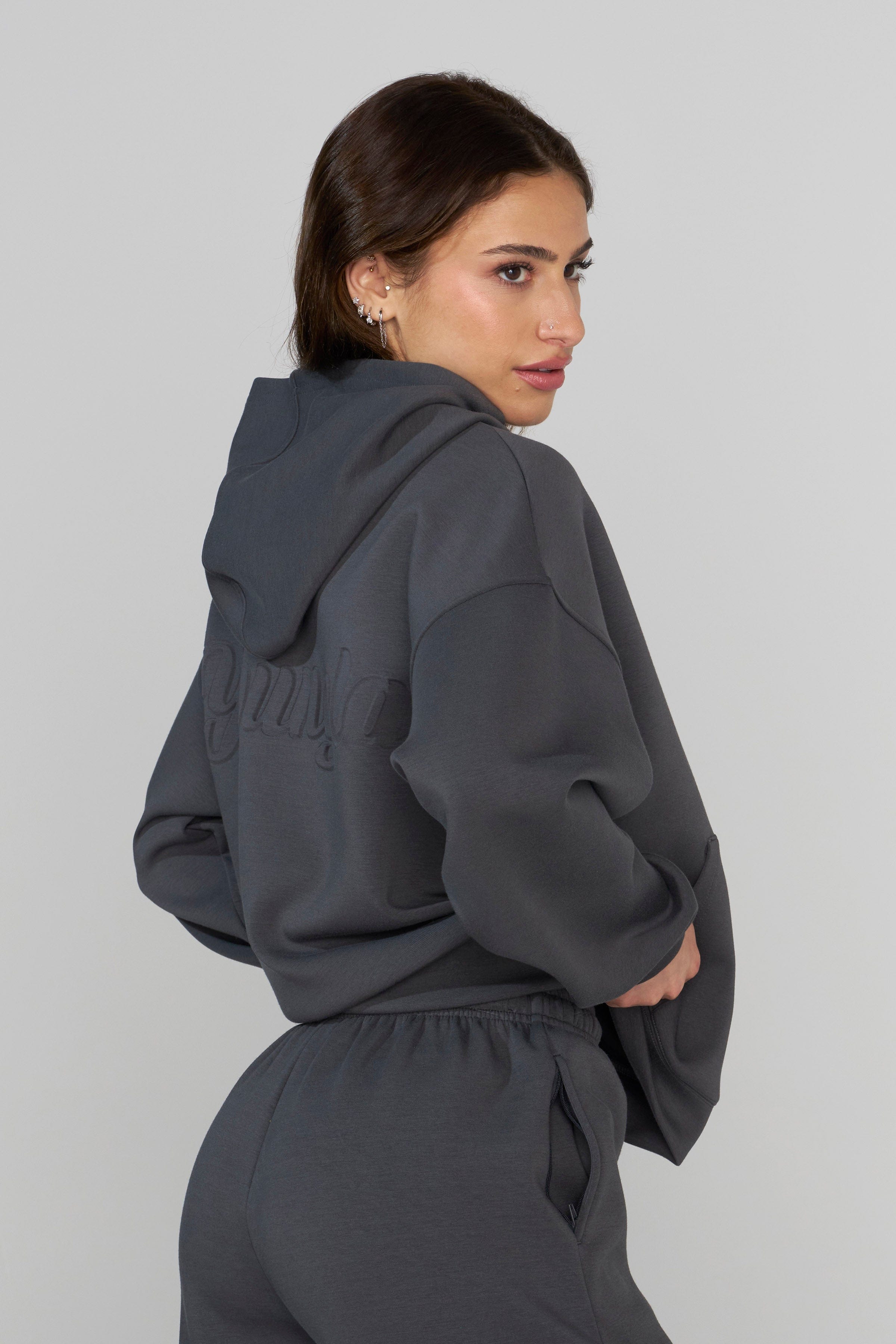 Close-up of the debossed logo on the scuba hoodie, highlighting its quality.