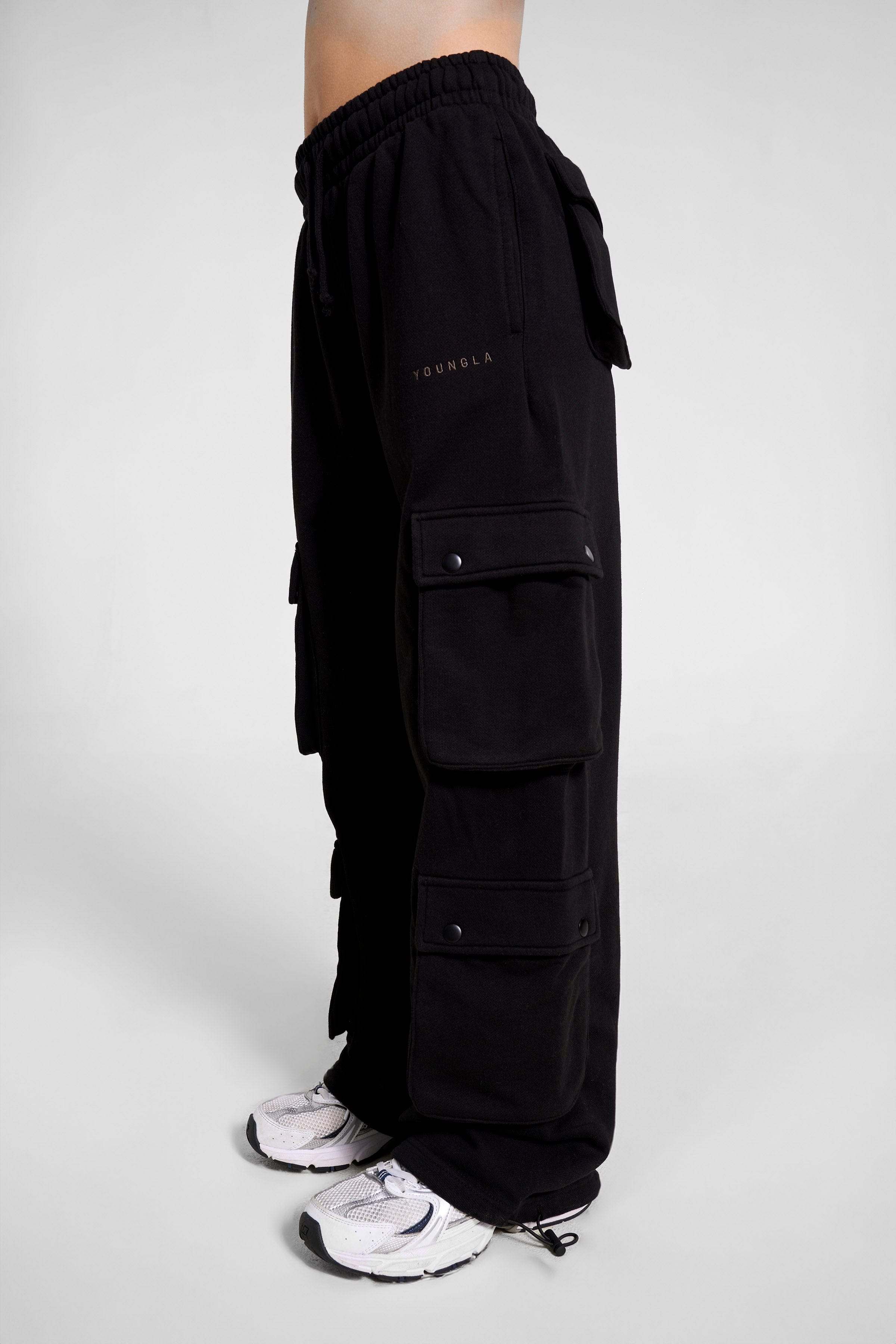 Close-up of mens cargo joggers in hunter green with cargo pockets for outdoor use