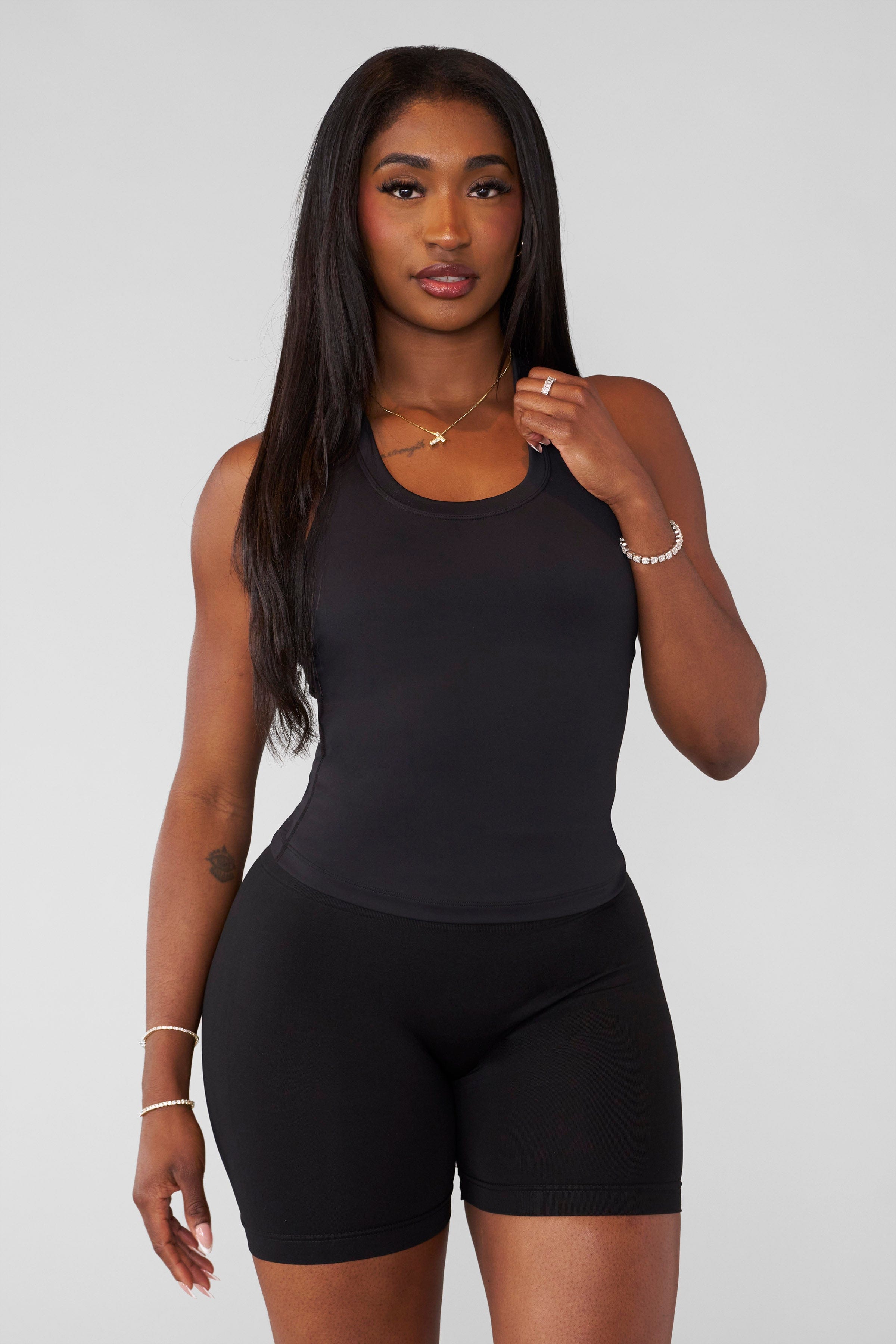 Model wearing the Core Luxe tank, highlighting its stylish design.