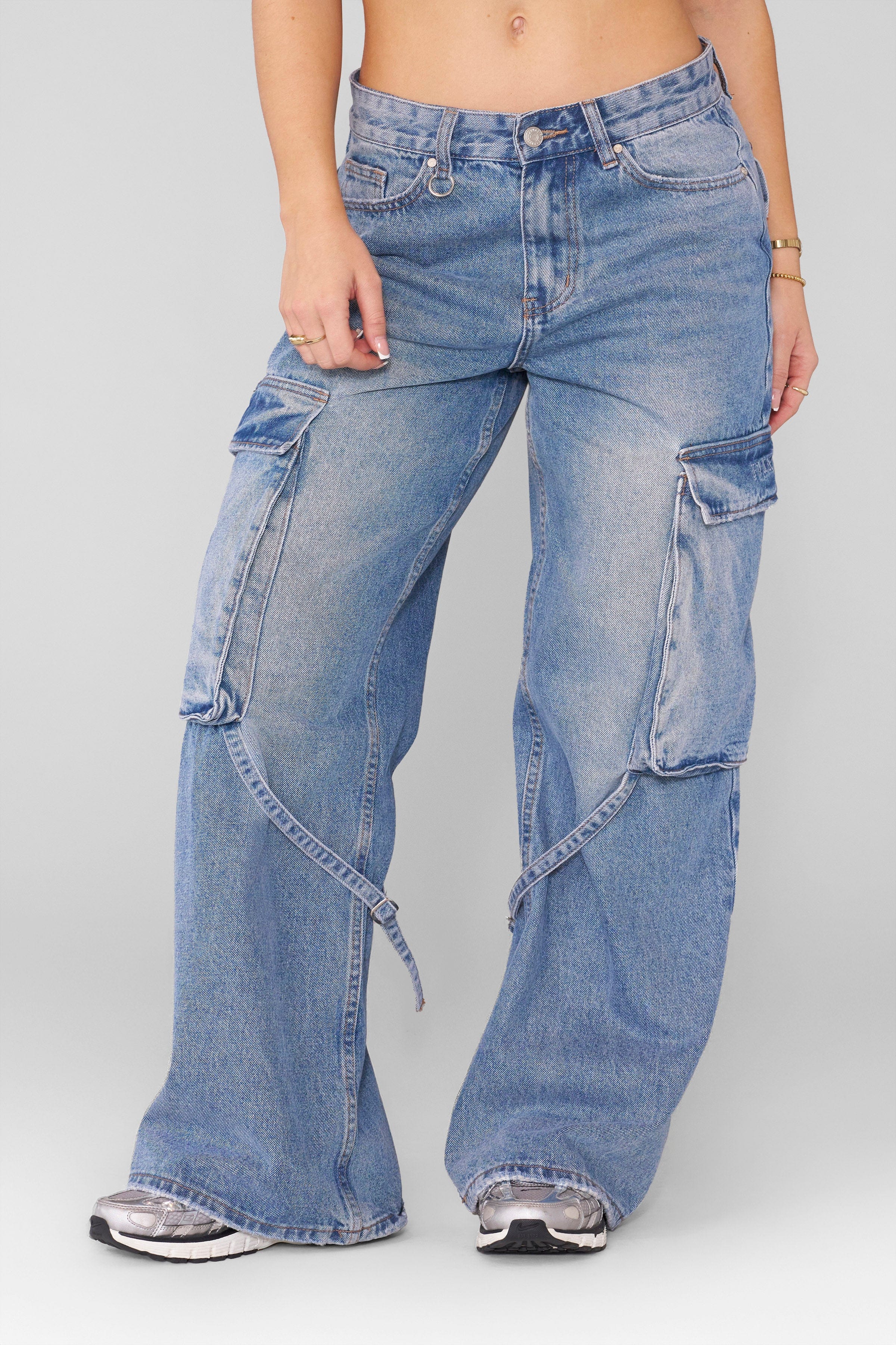 Front view of dominate jeans styled with boots, showing full straight-leg silhouette.
