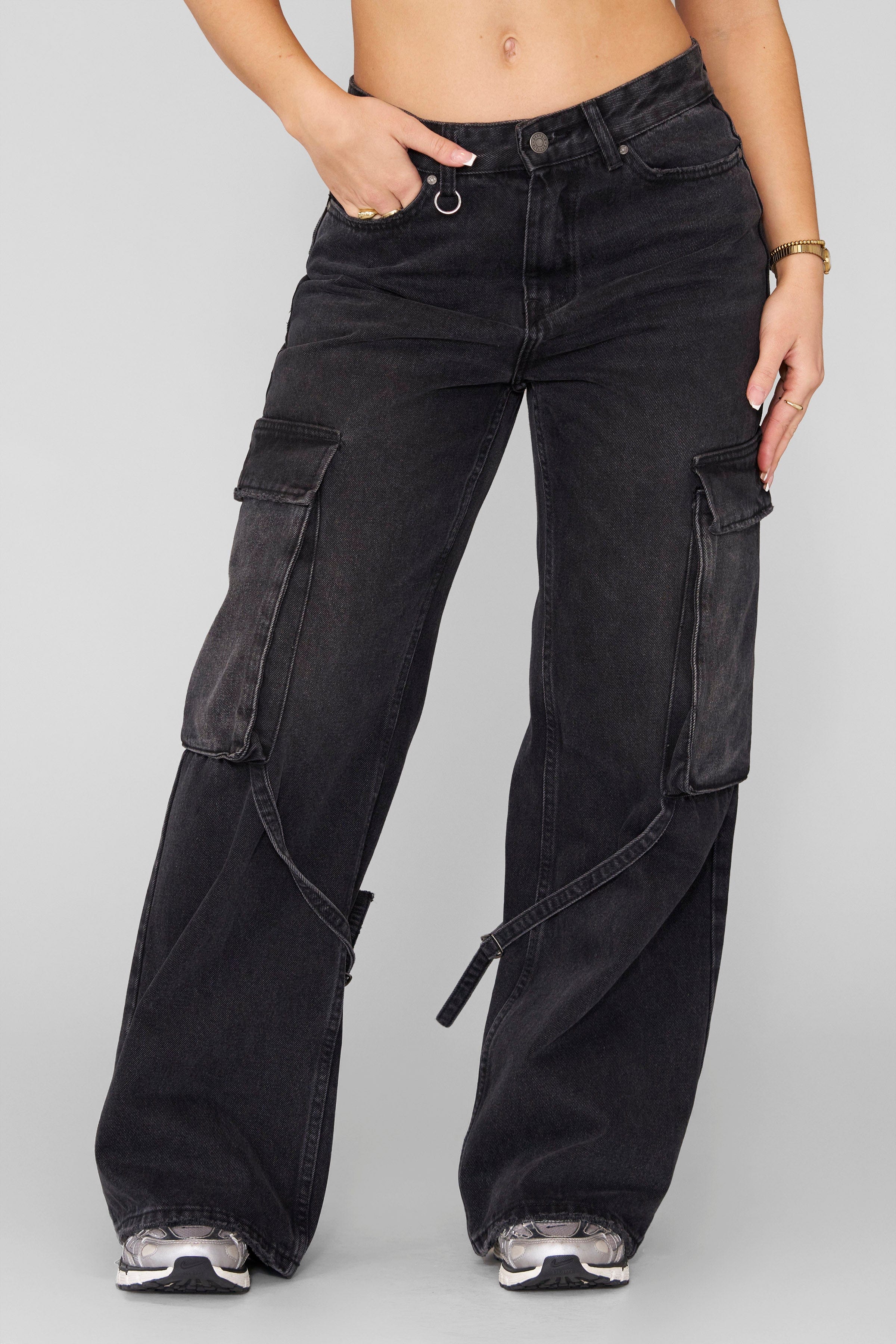 Front view of dominate jeans styled with boots, showing full straight-leg silhouette.