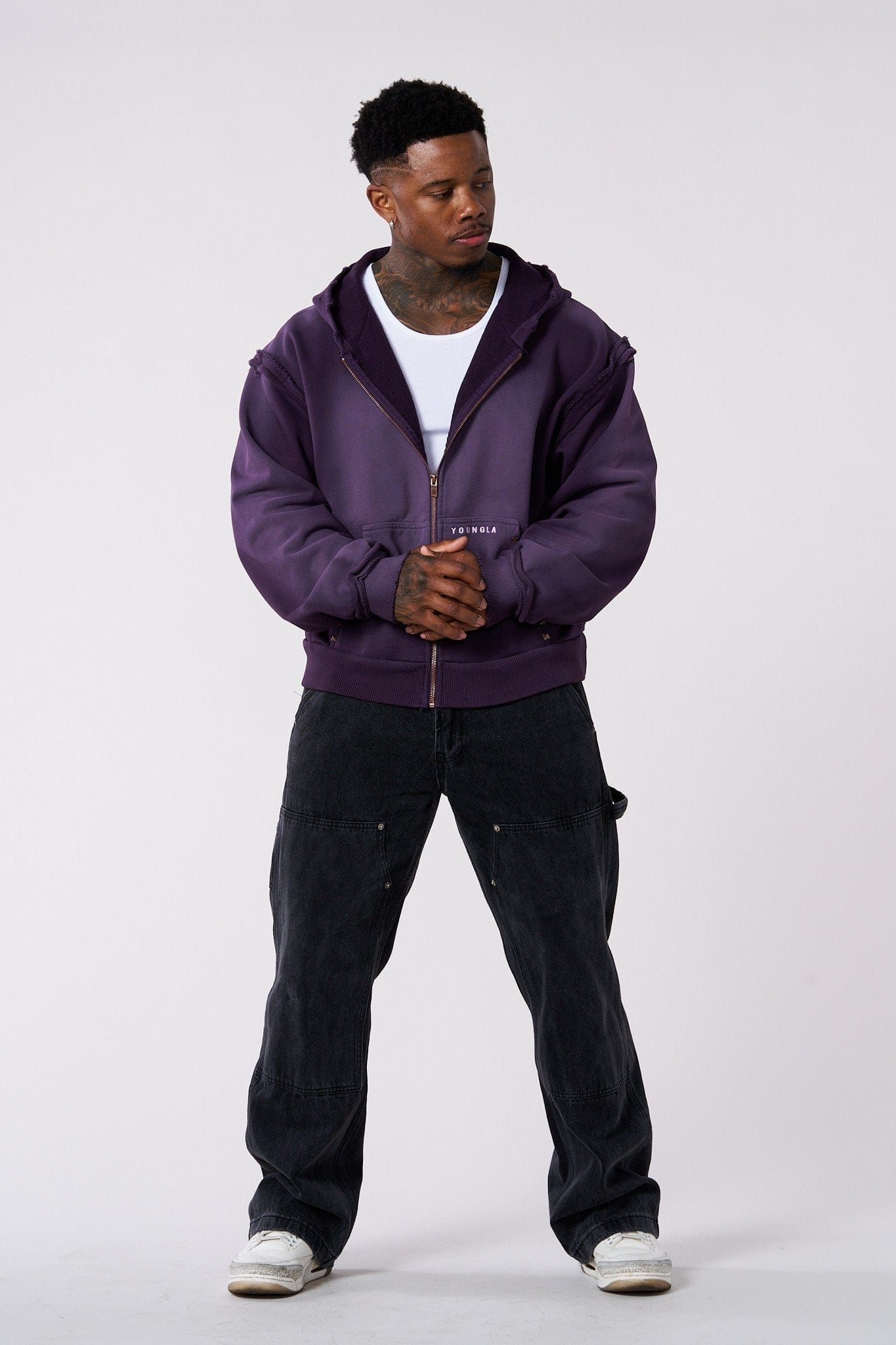 Model showcasing the boxy fit and short length of the deconstructed terry hoodie