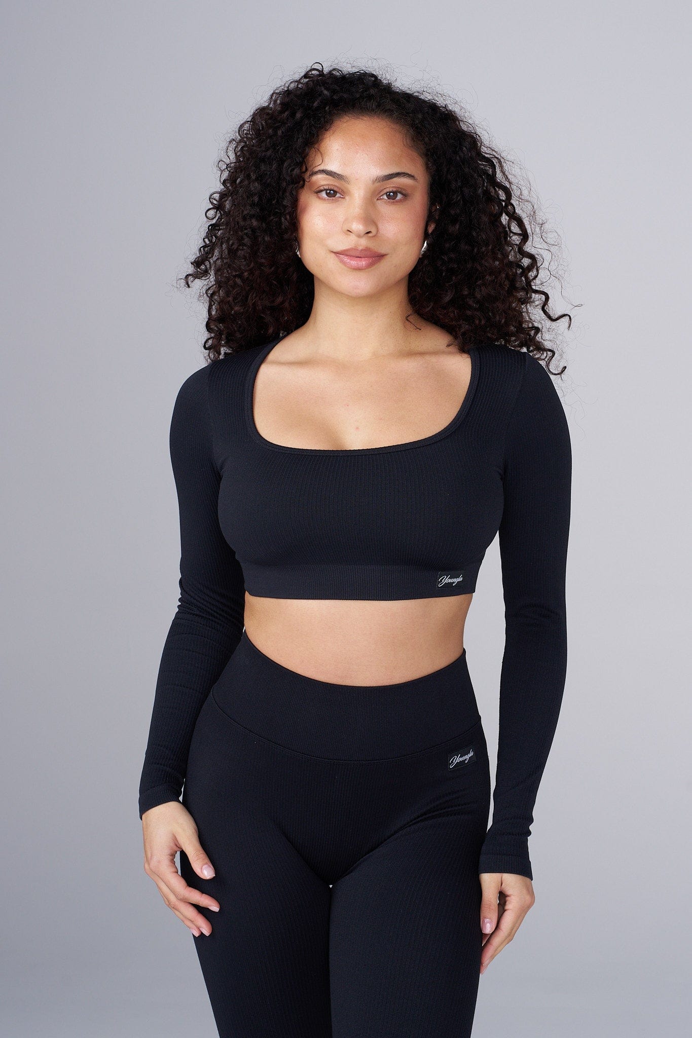 Side angle of ribbed top showing textured stretch and fit.