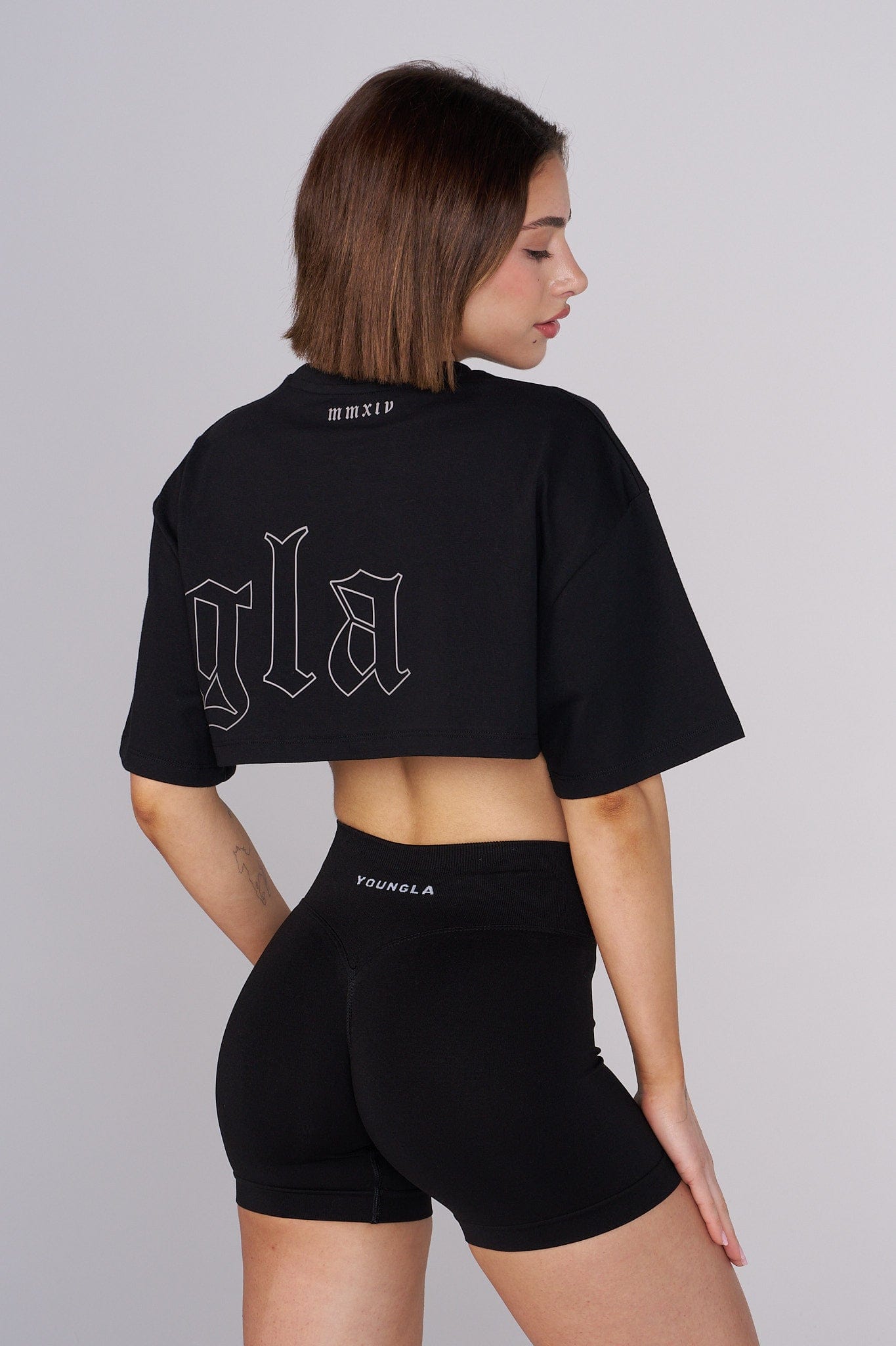 Model wearing the cropped tee, styled with high-waisted jeans.