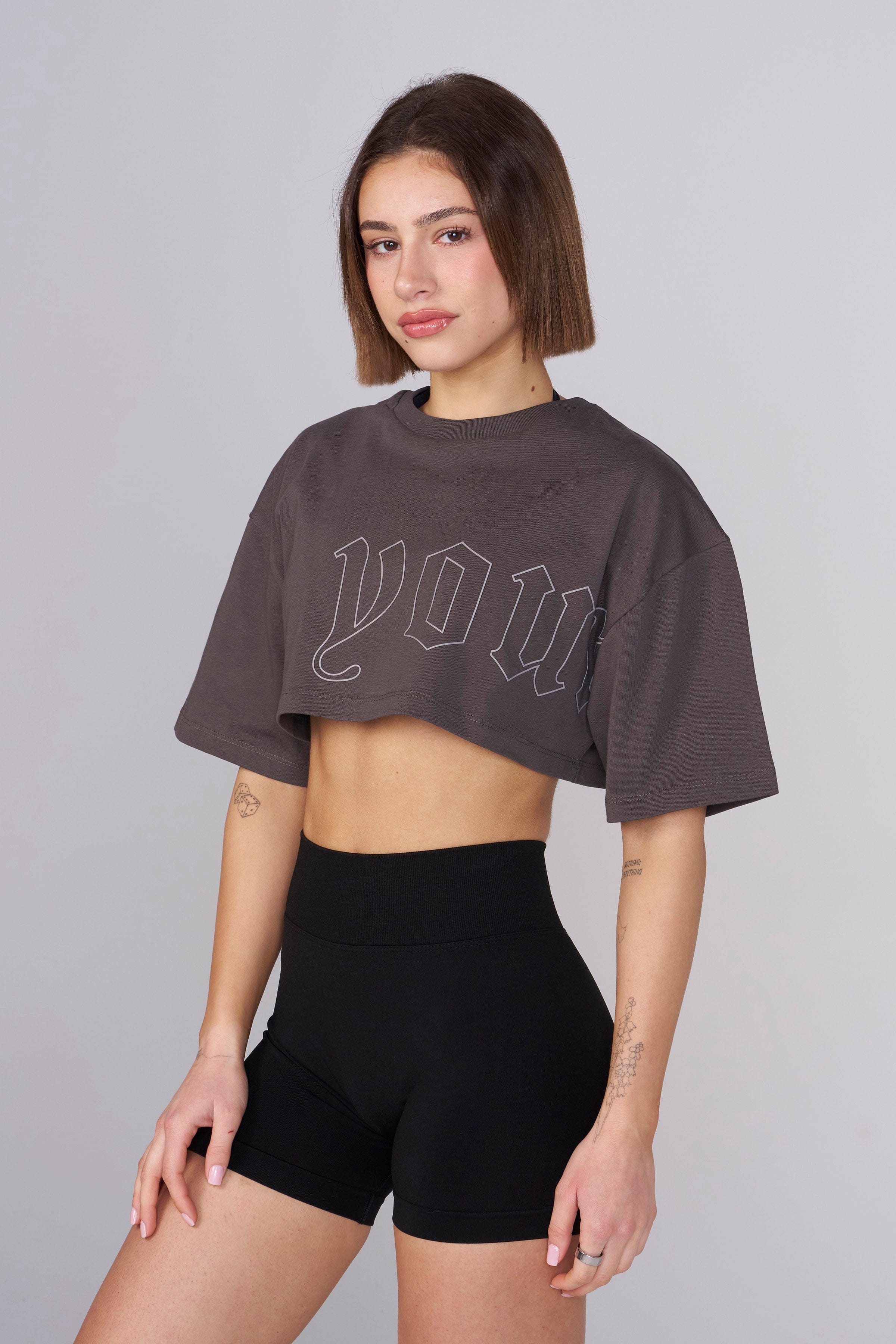 Model wearing the cropped tee, styled with high-waisted jeans.