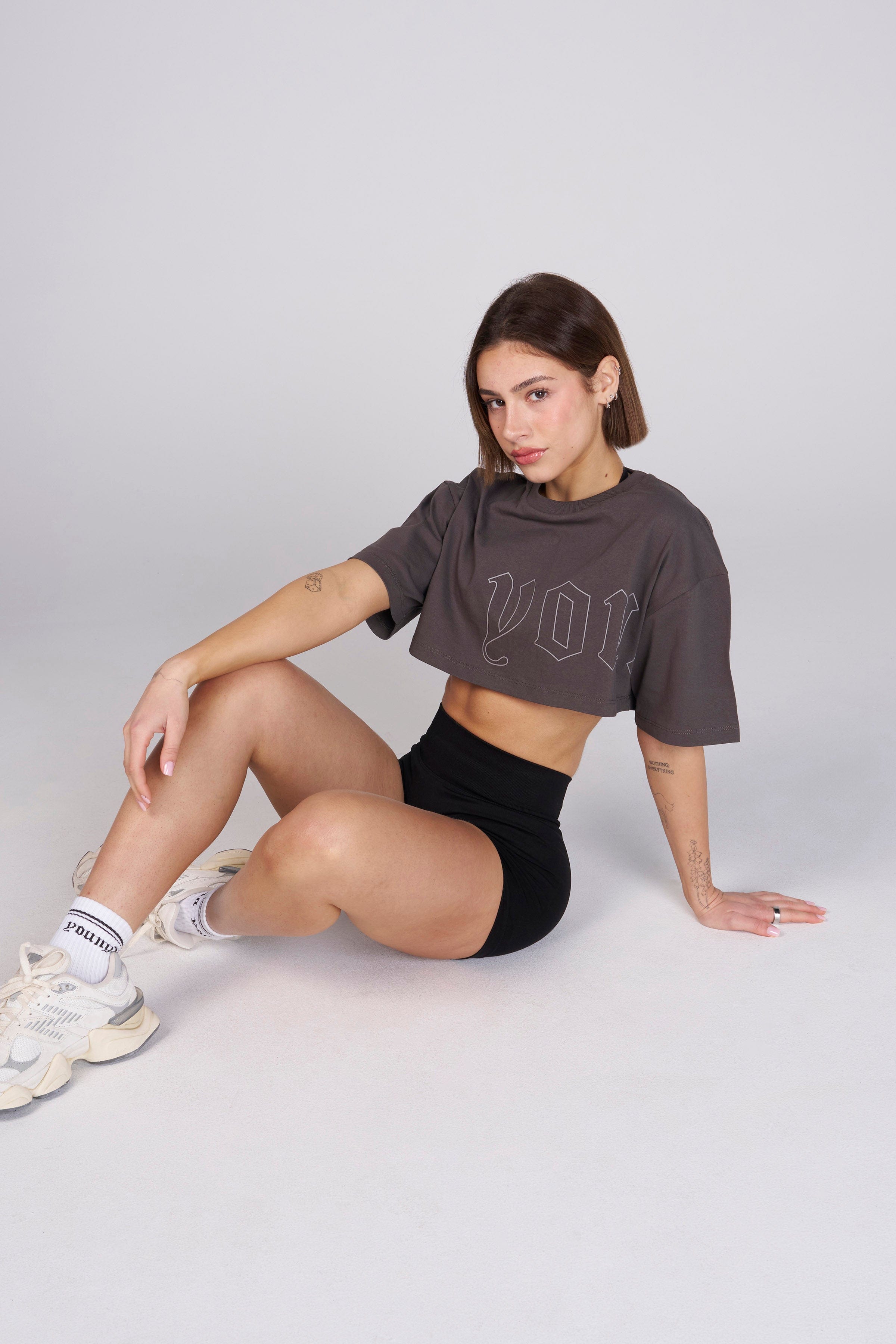 Model wearing the cropped tee, styled with high-waisted jeans.