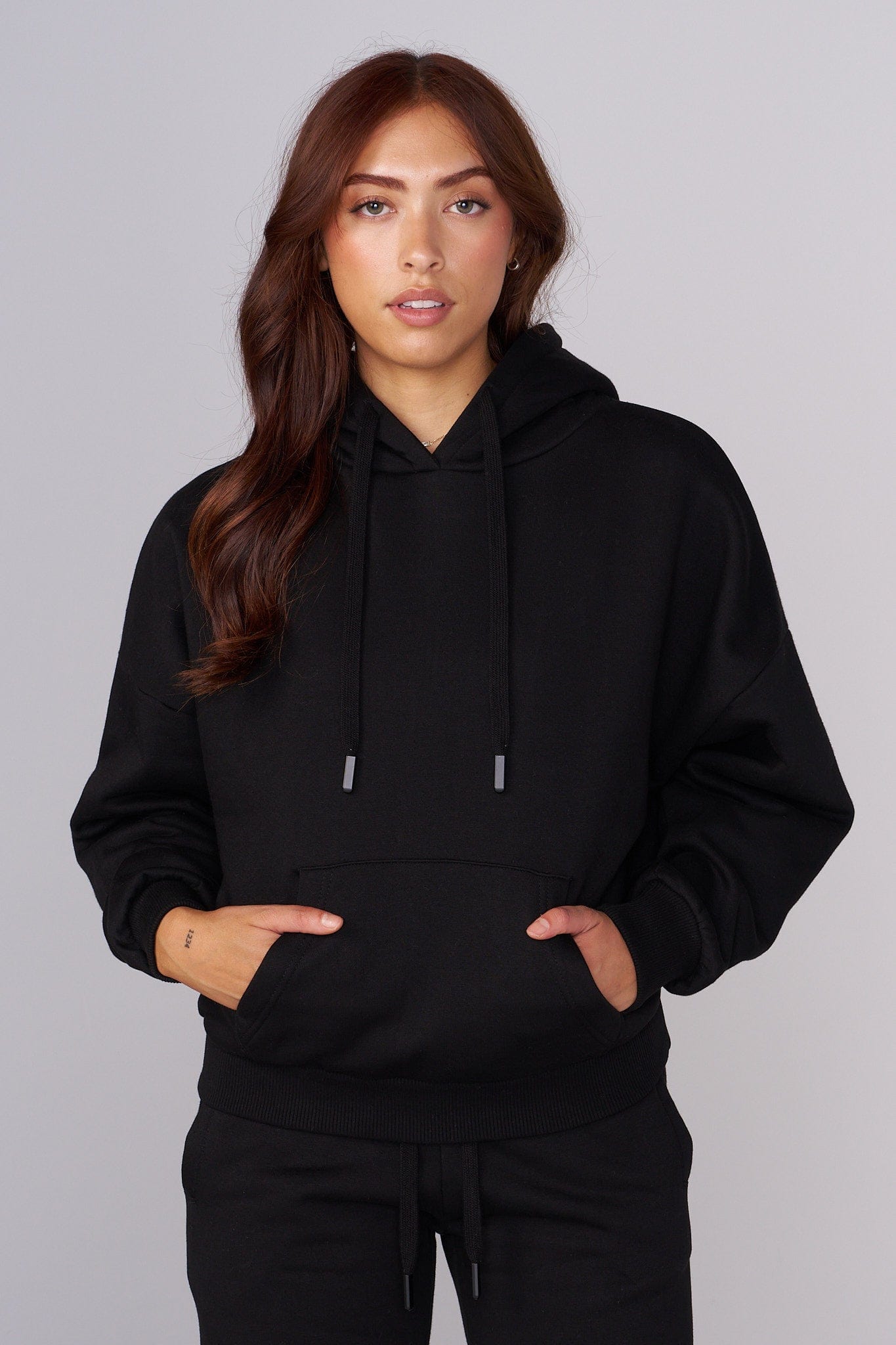 Close-up of the embroidered detail on the oversized hoodie.