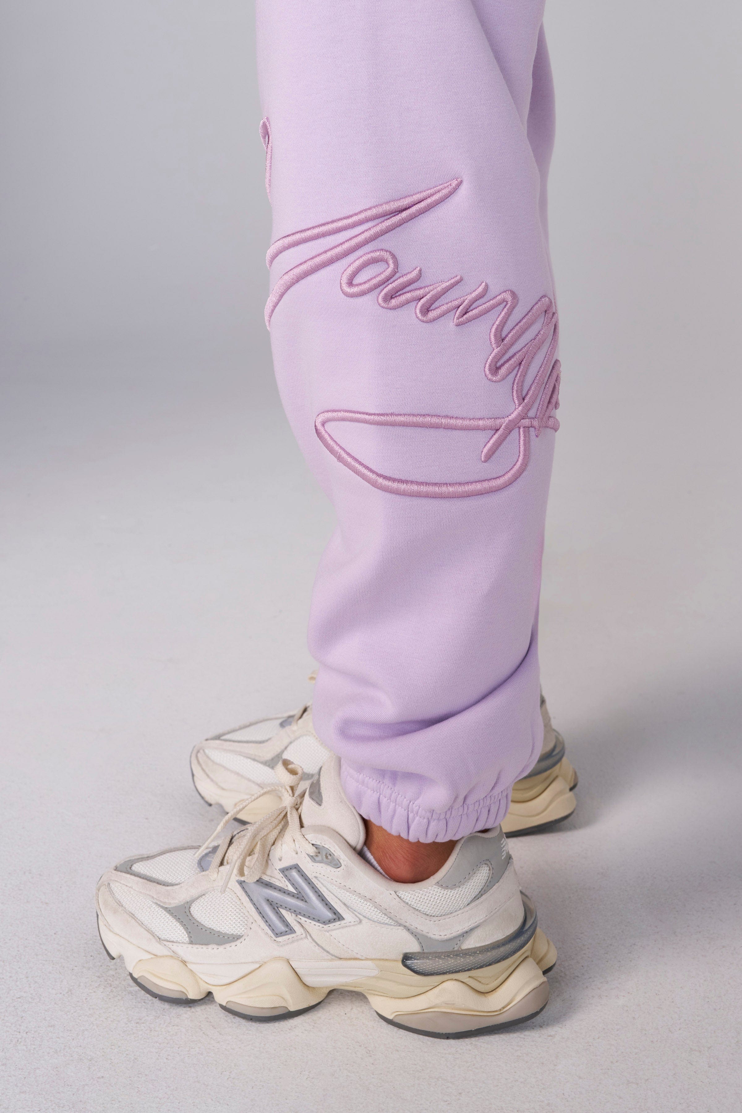 Model in signature joggers showcasing vibrant spring colors.