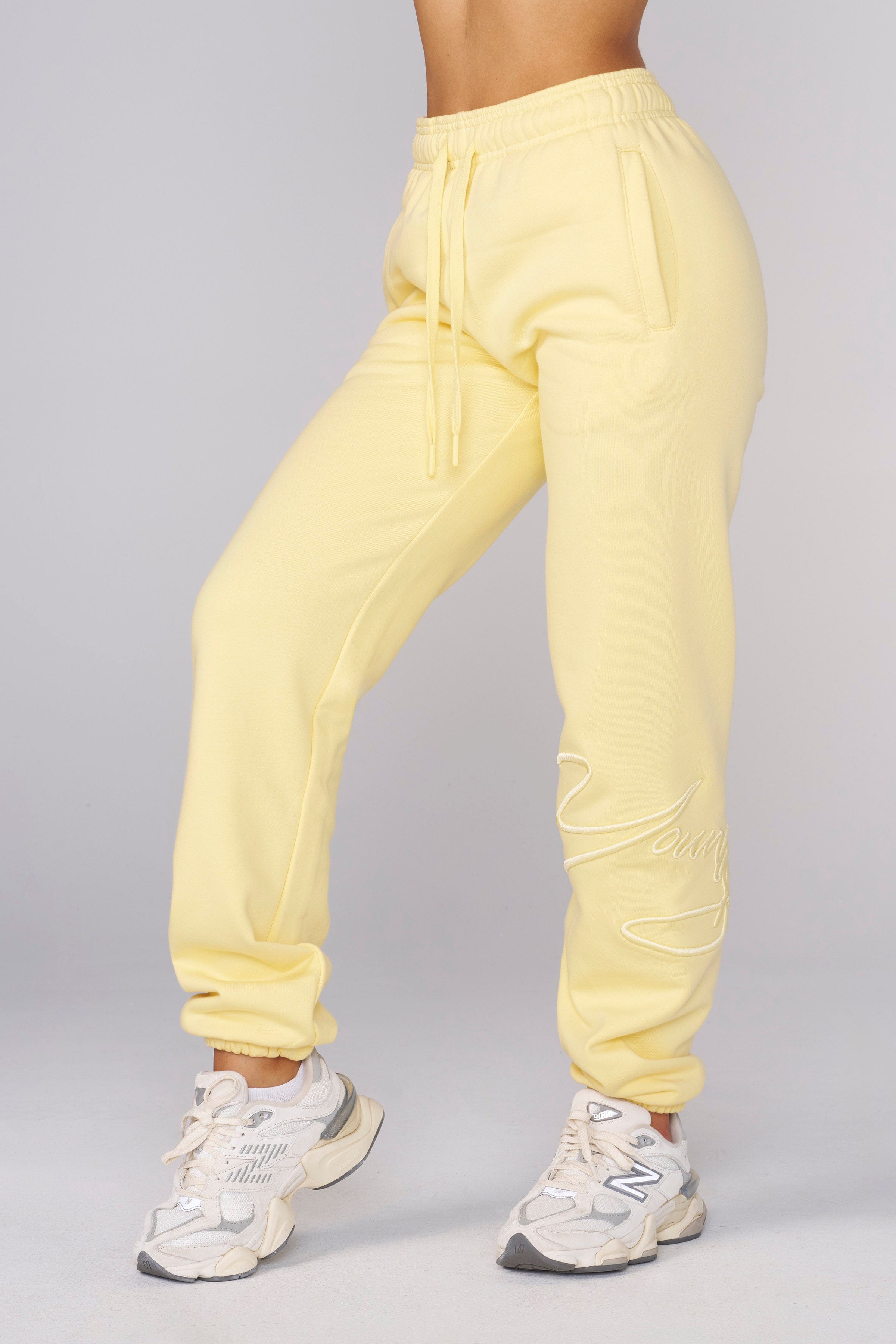 Model in signature joggers showcasing vibrant spring colors.