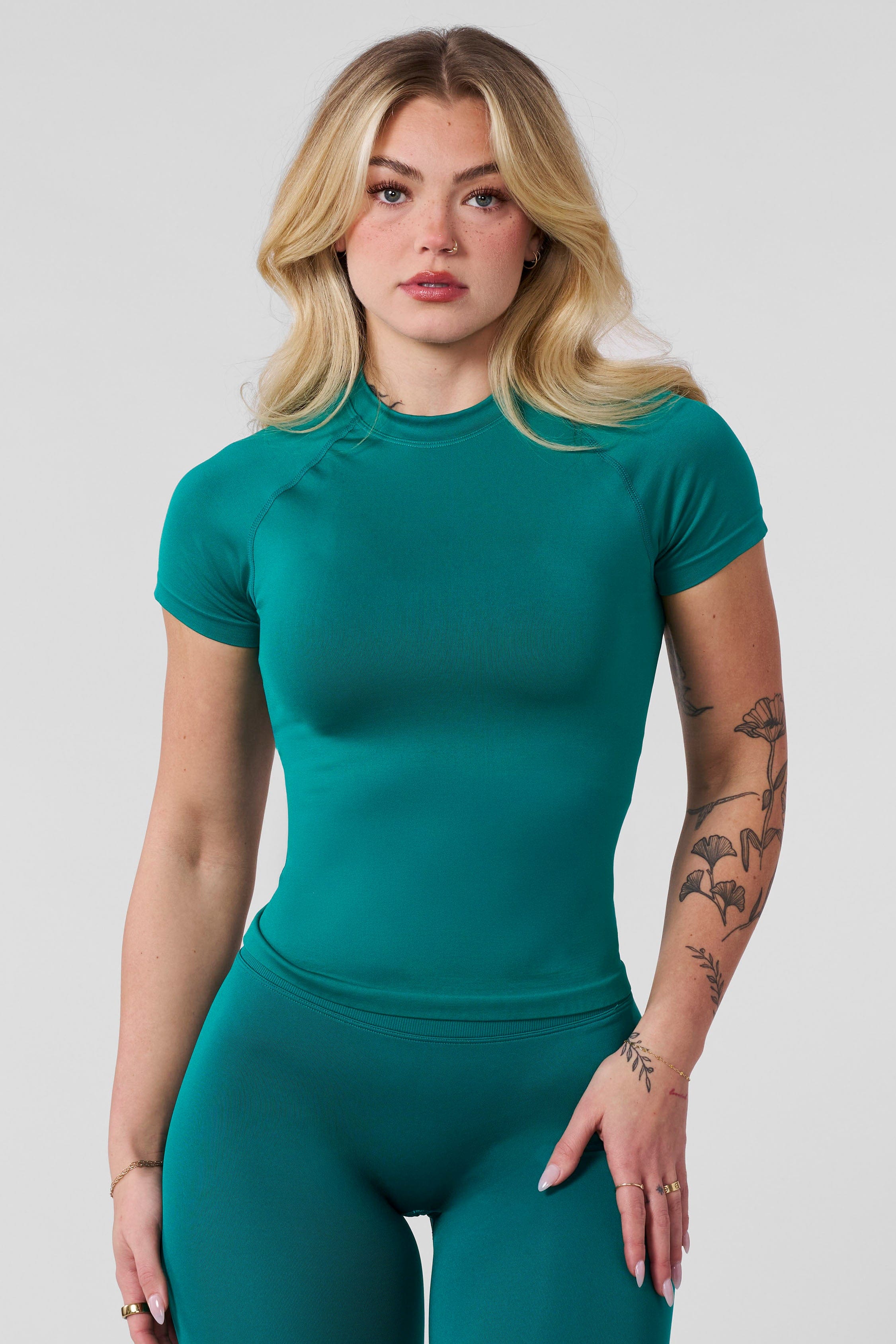 Side profile highlighting breathable knit of compression tee layered with athletic shirts.
