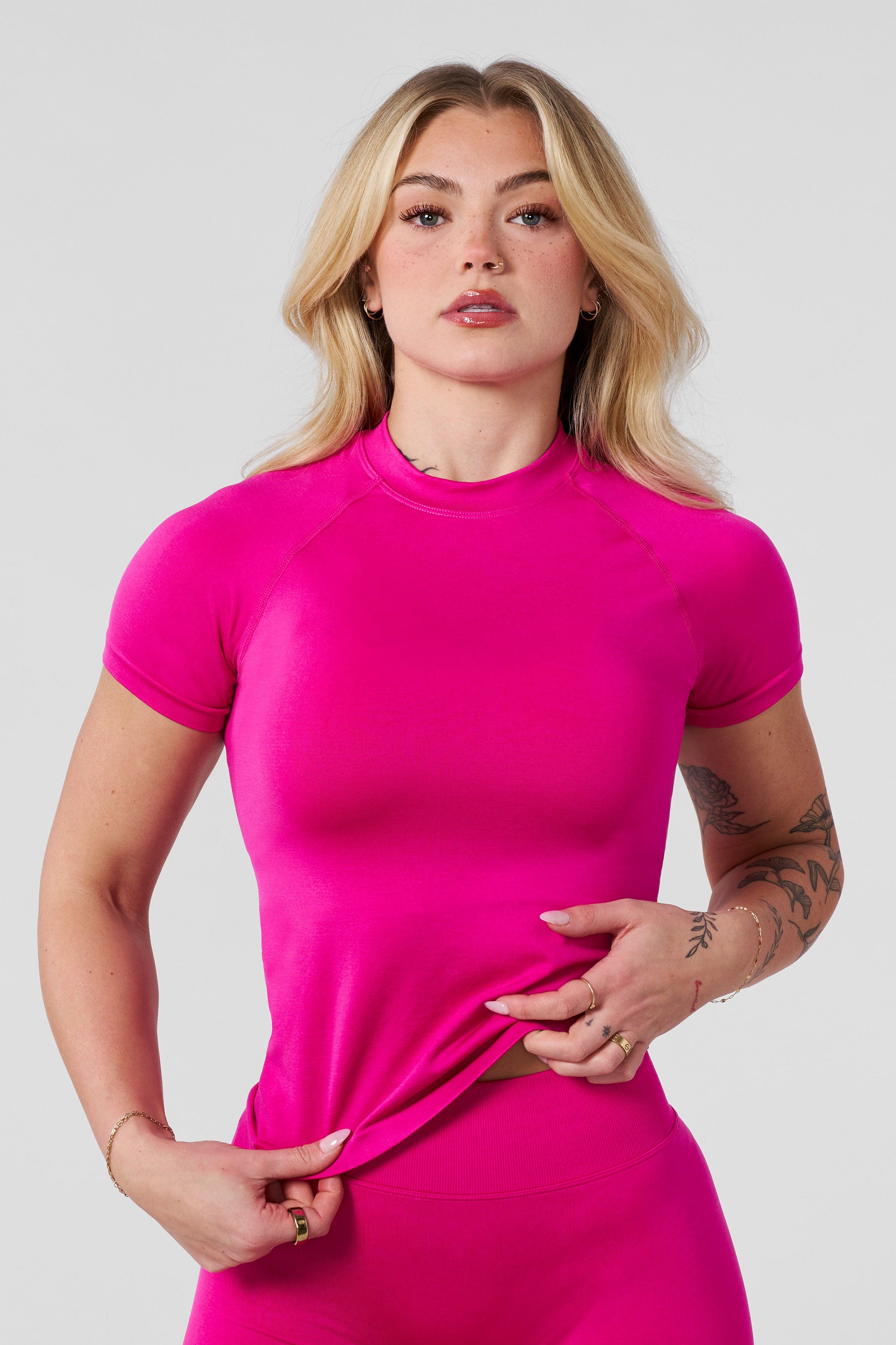 Front angle of seamless compression tee styled with seamless biker shorts for training.