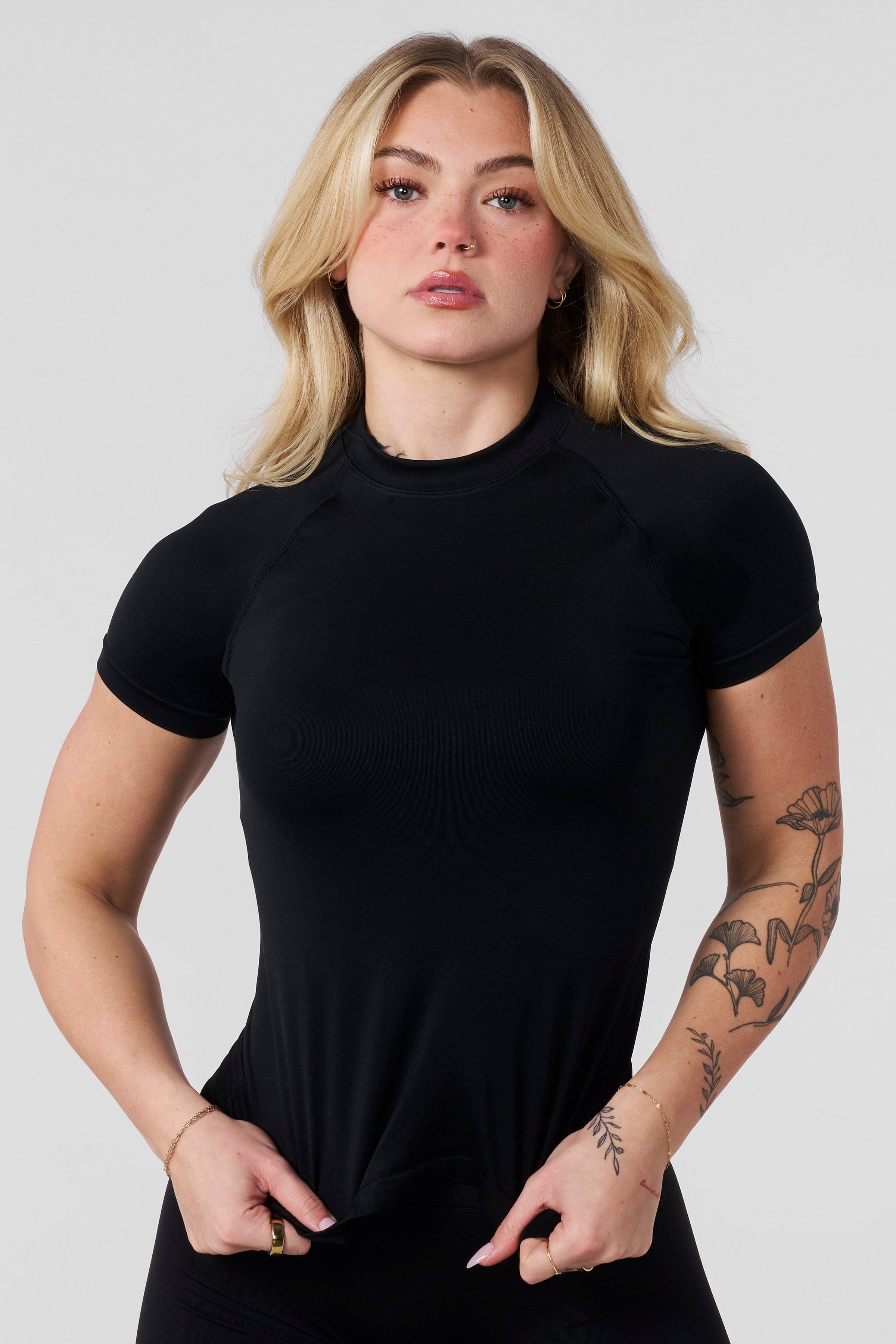 Front angle of seamless compression tee styled with seamless biker shorts for training.