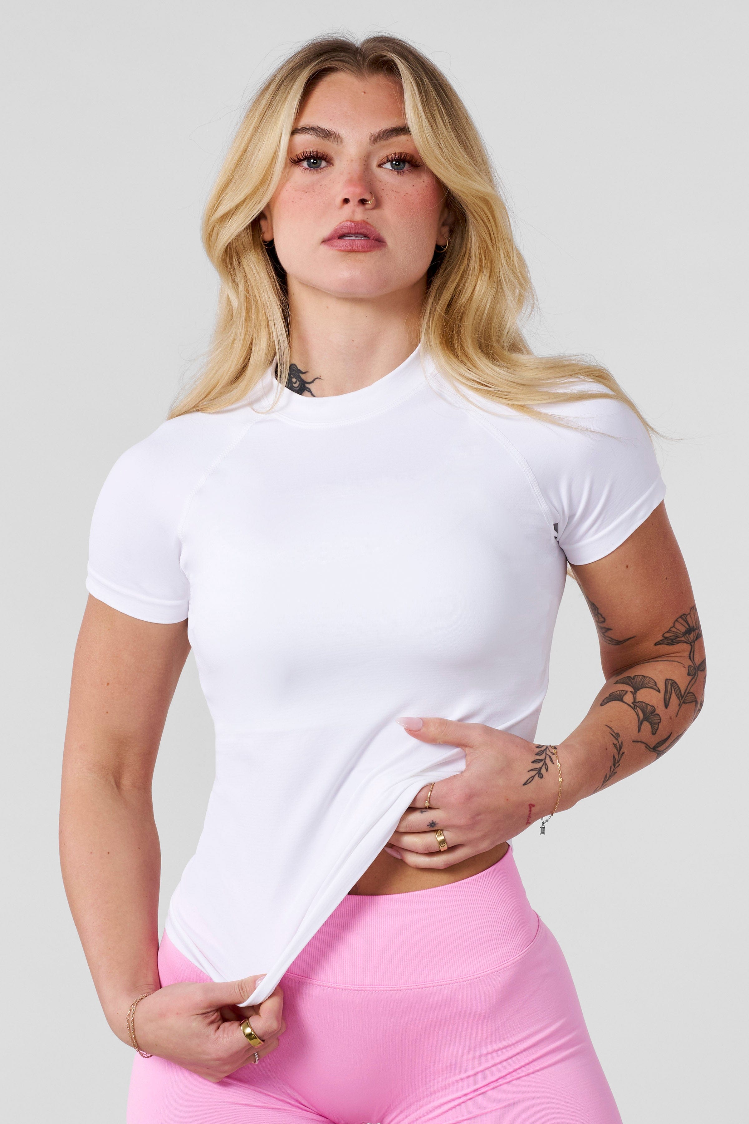 Front angle of seamless compression tee styled with seamless biker shorts for training.