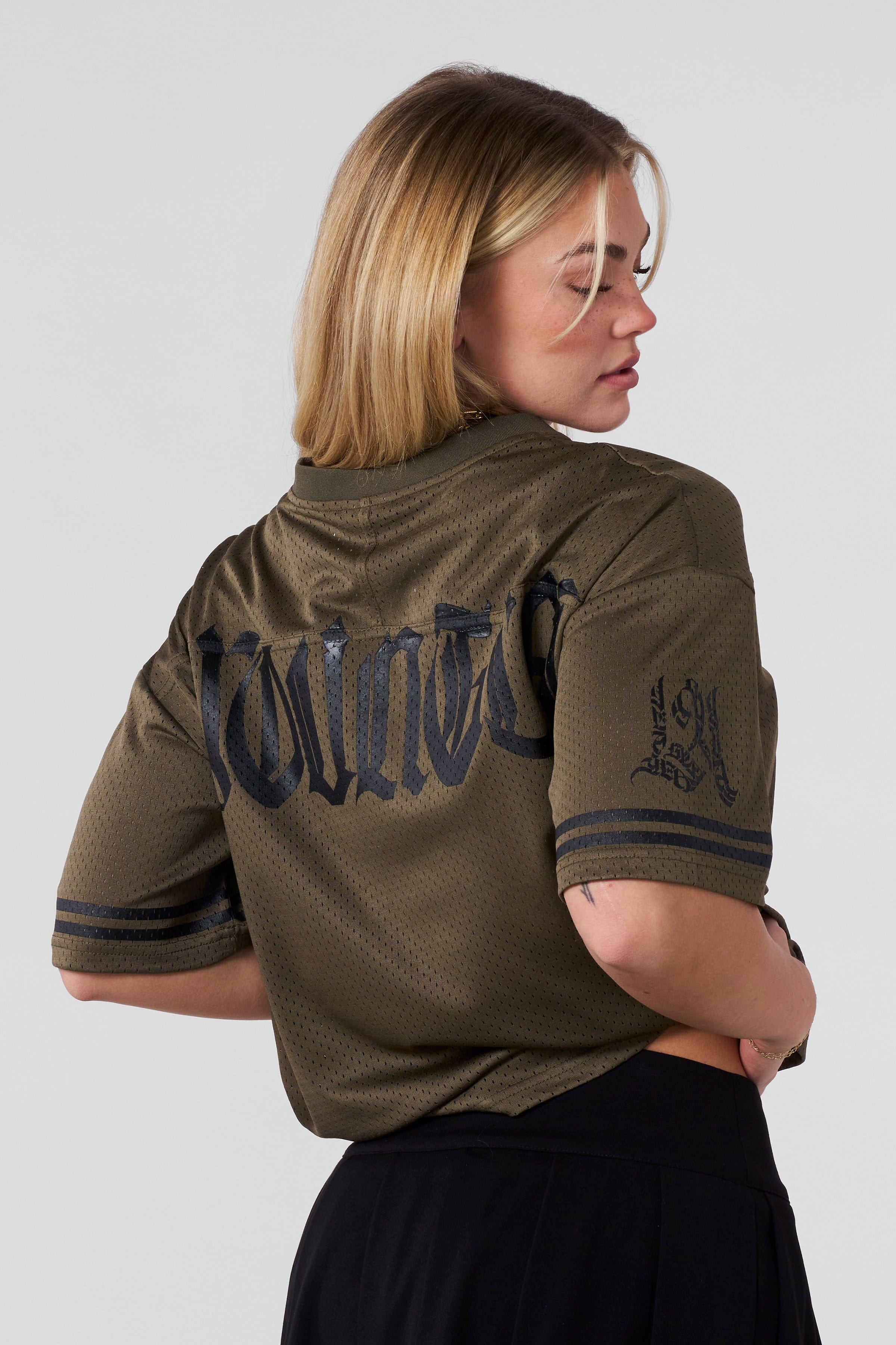 Model wearing the fitness jersey during a morning run in the park