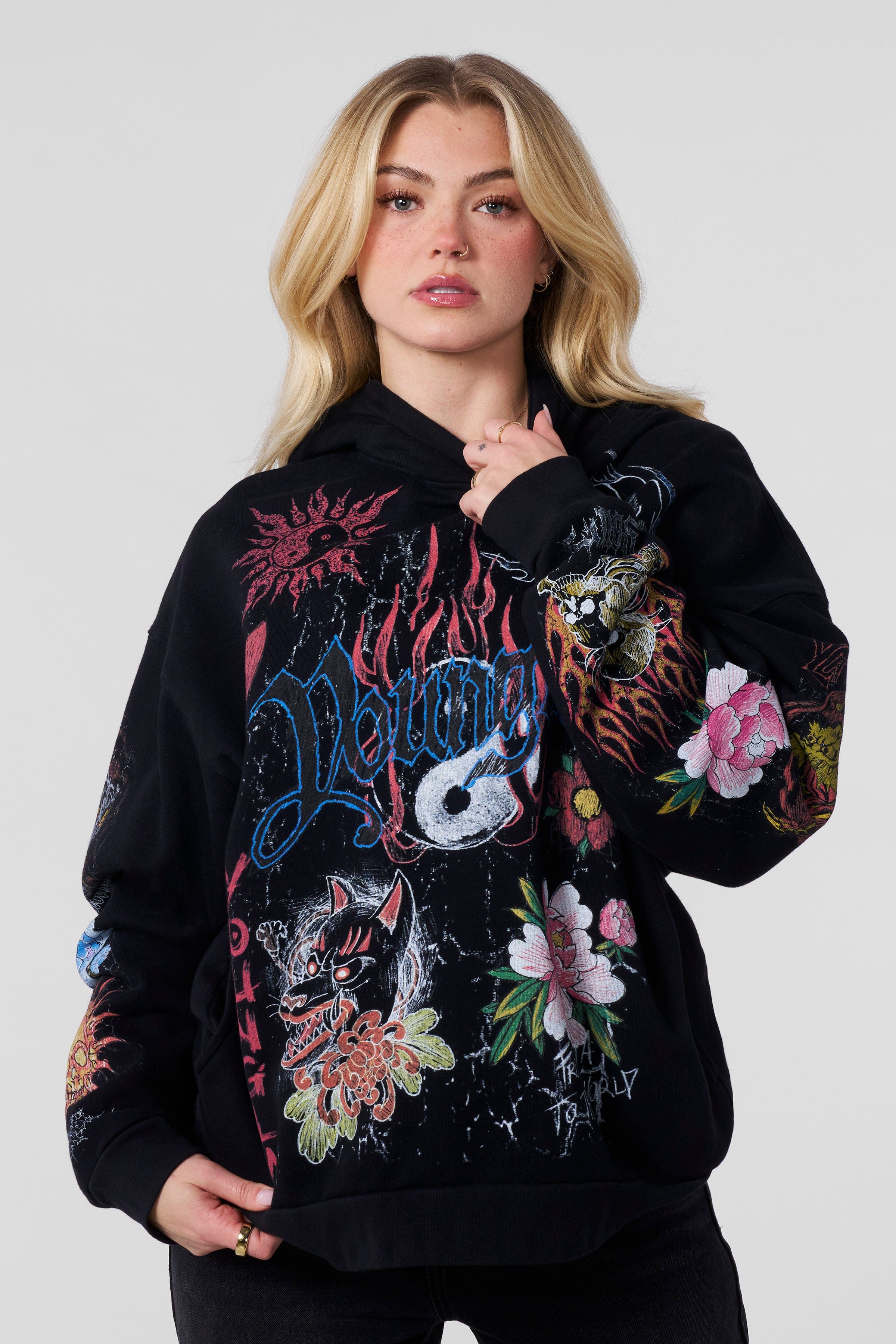 Front view of oversized hoodie in flame-red with streetwear-style ink illustration