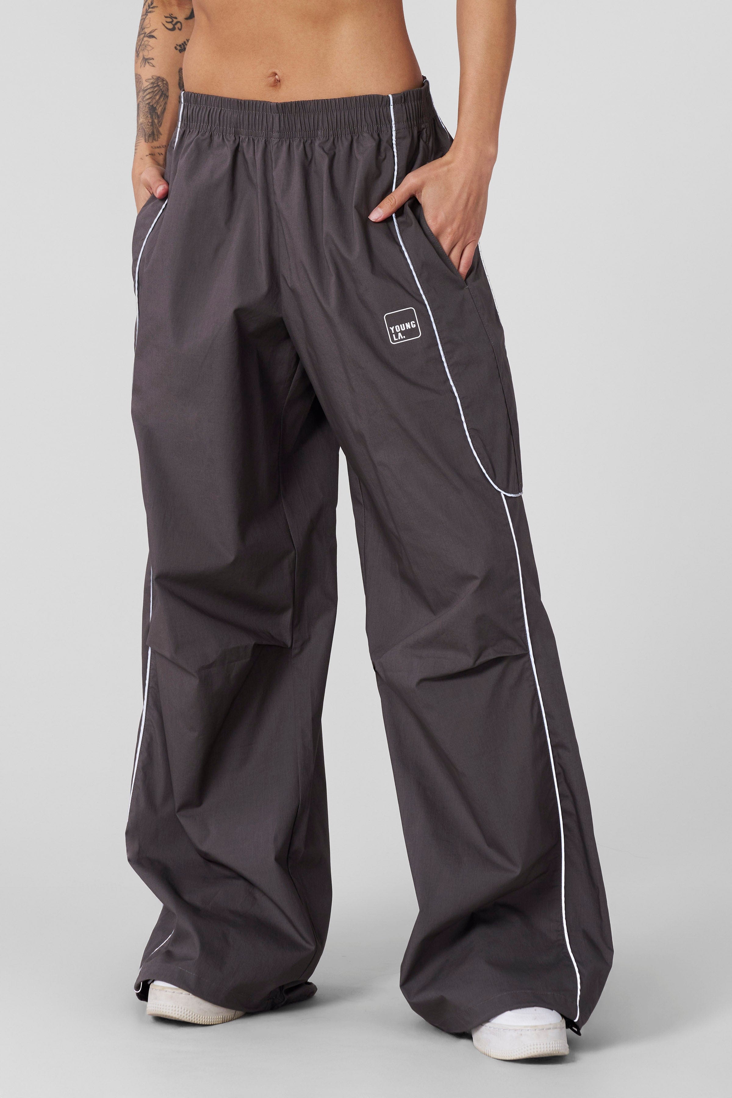 Active woman wearing reflective track pants during outdoor exercise