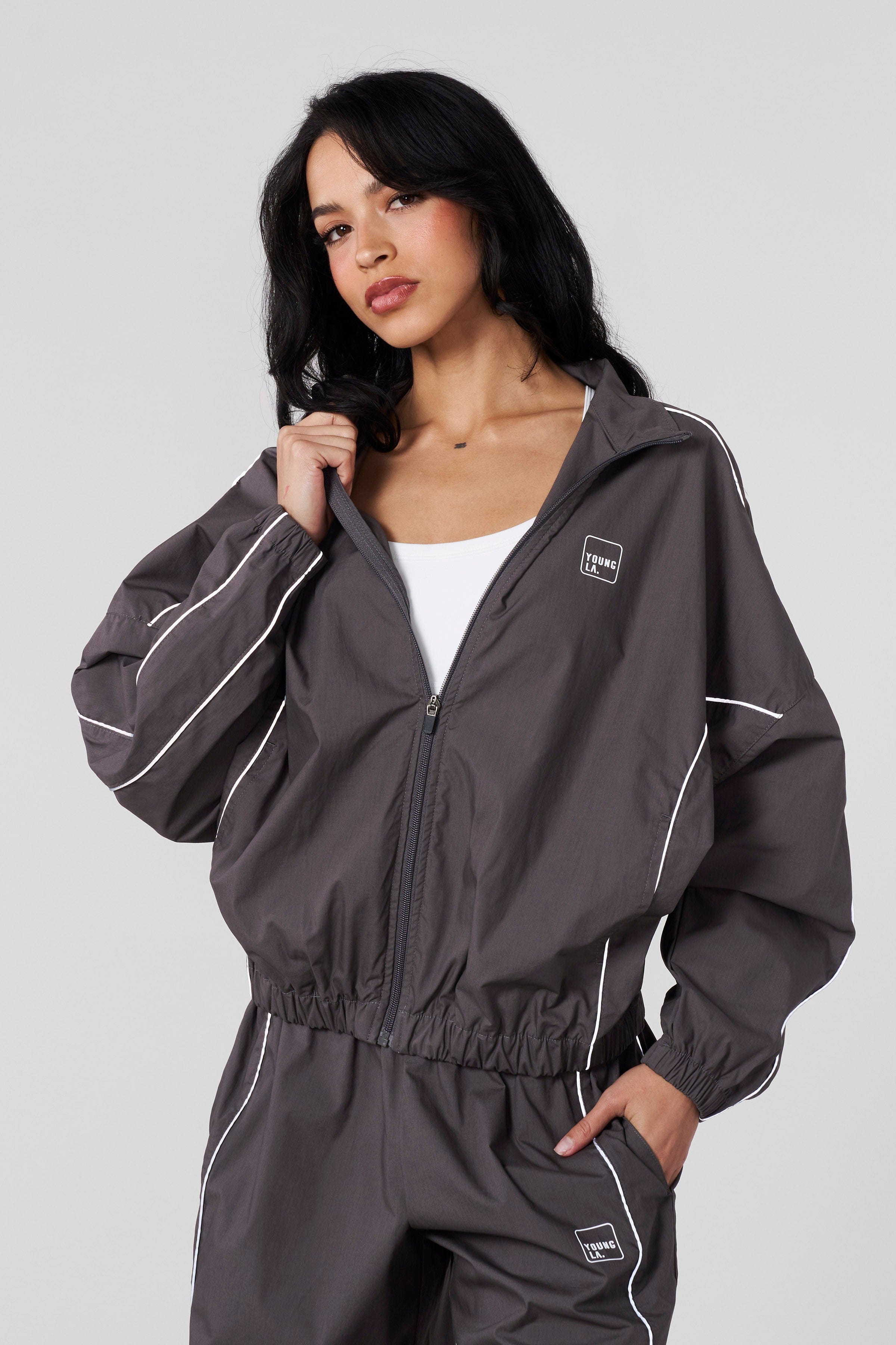 Front view of the Flash Womens Windbreaker Jacket showcasing its sporty design.