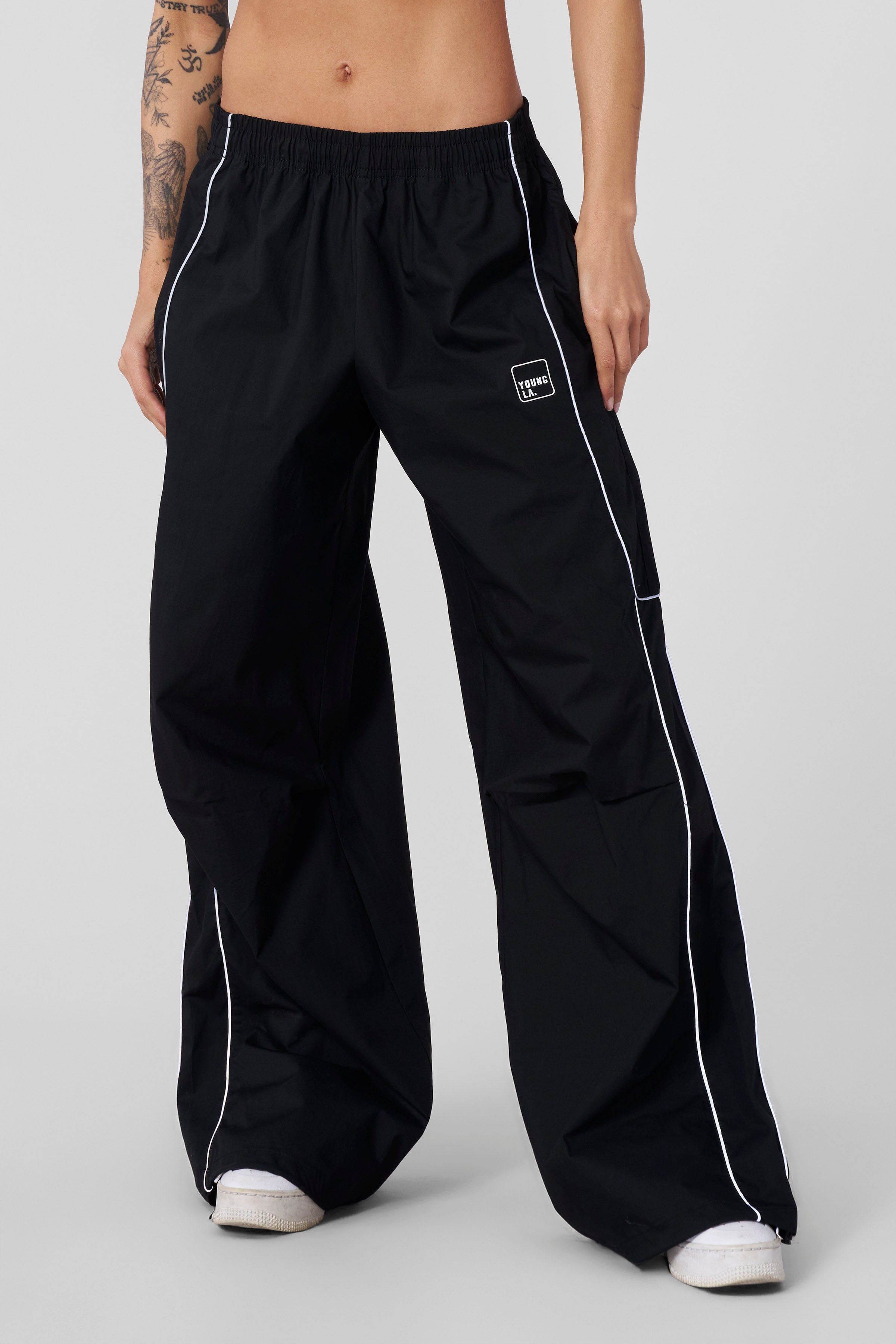 Front view of baggy track pants with adjustable hem for a relaxed fit