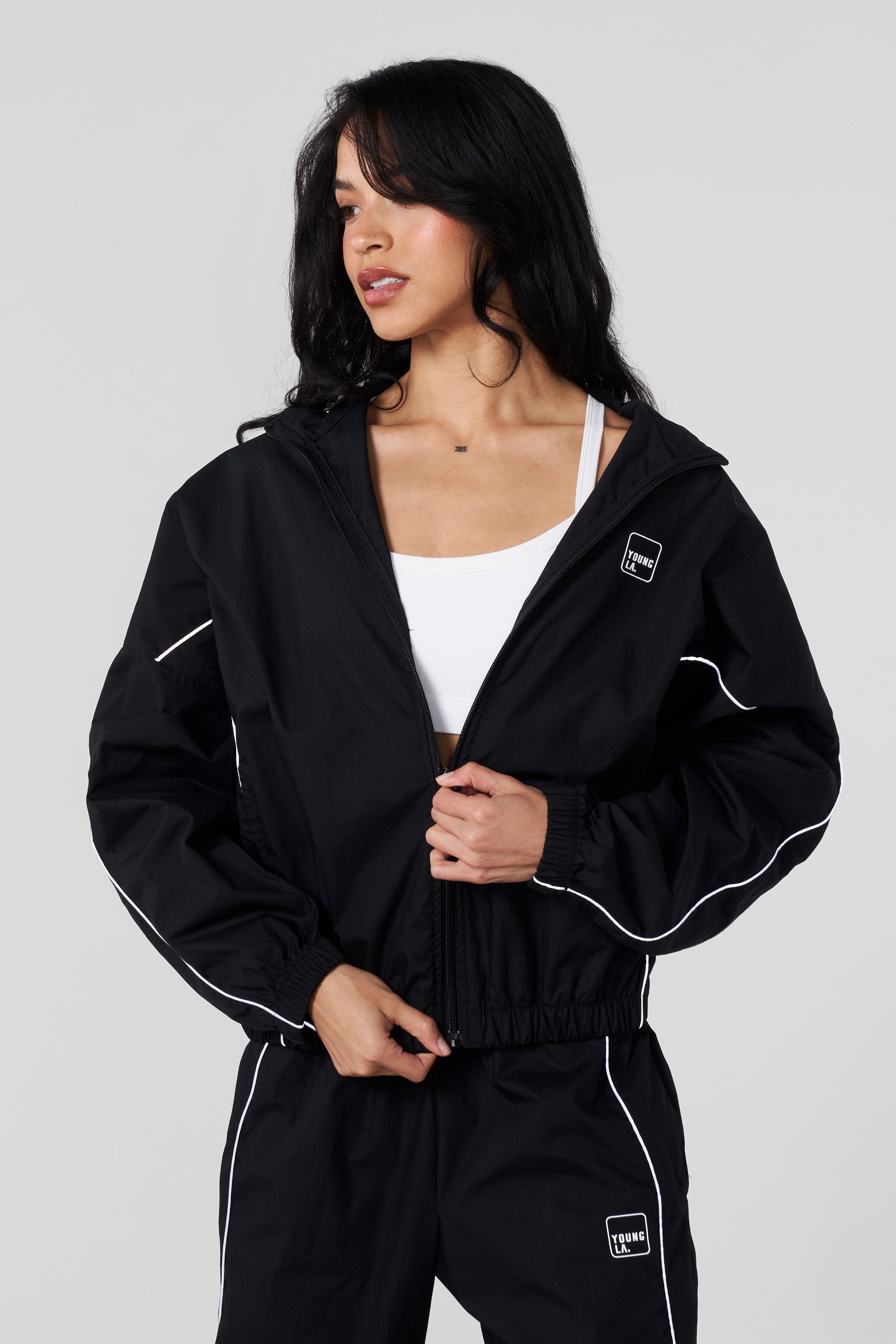 Model wearing the Flash Womens Windbreaker Jacket during an outdoor activity.