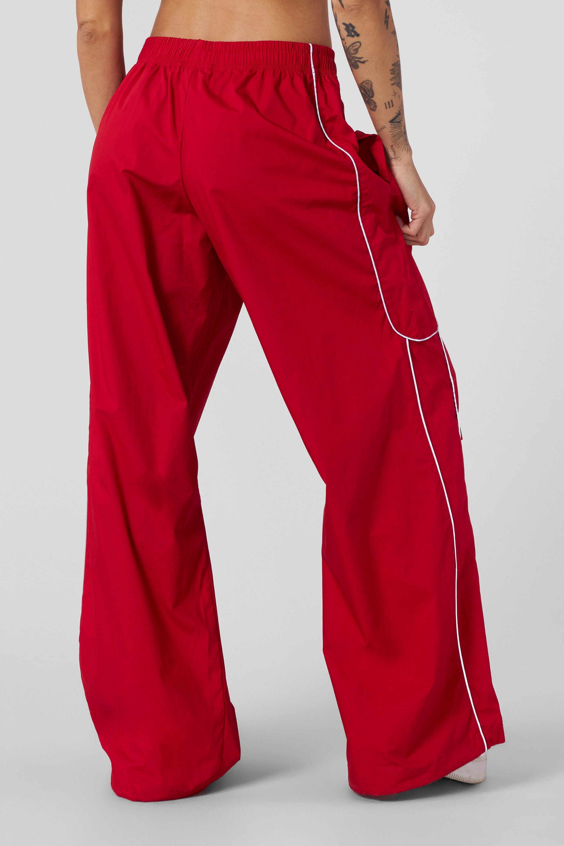 Active woman wearing reflective track pants during outdoor exercise