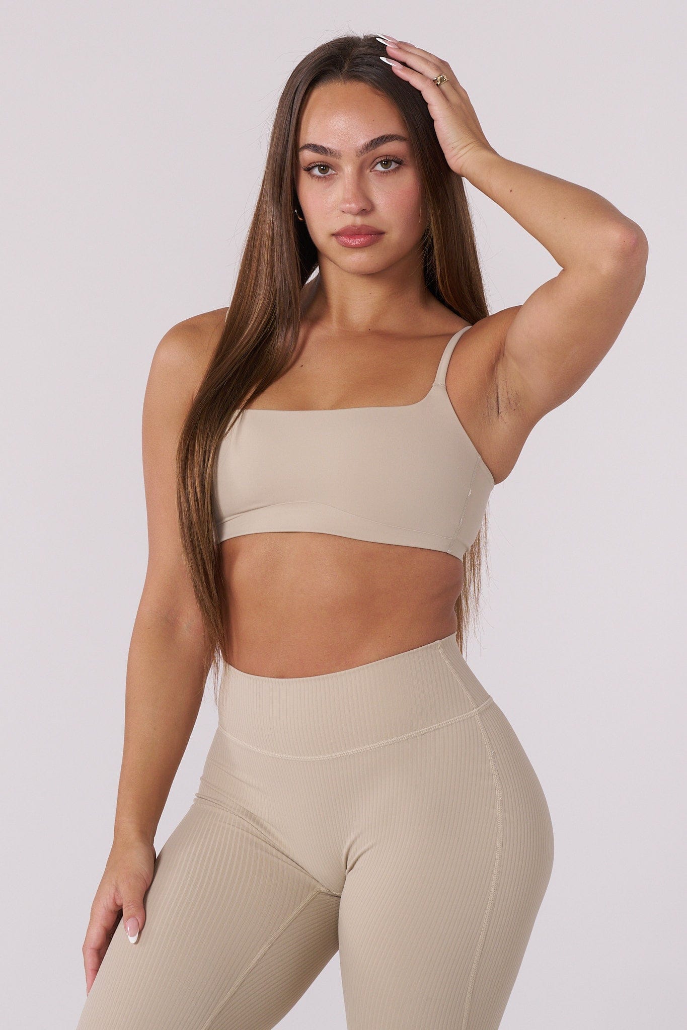 Front view of the Luna high support sports bra showing sleek design and neutral color