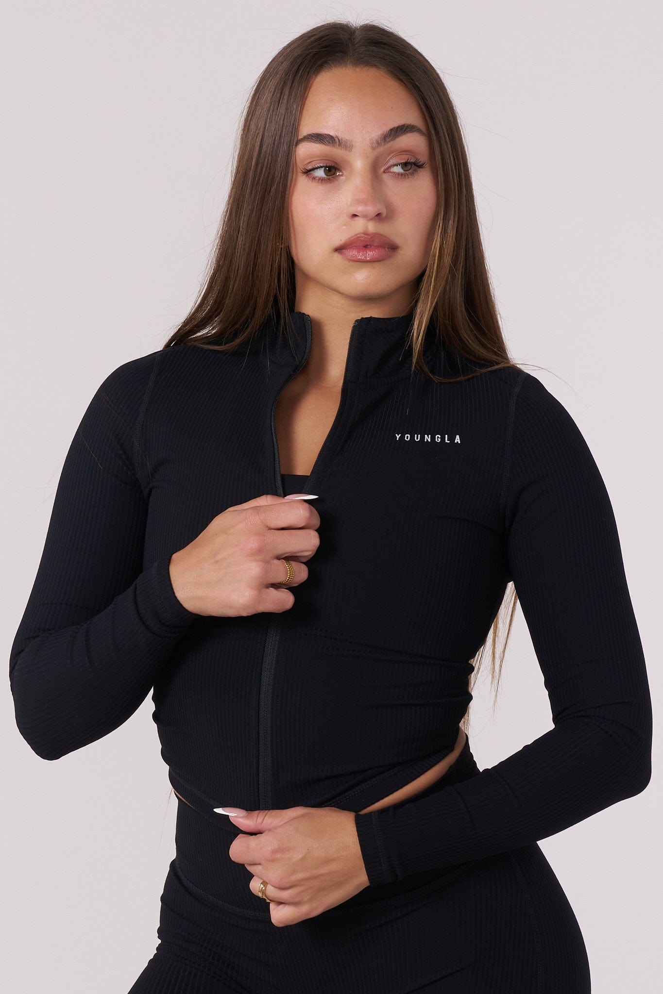 Close-up of the thumbholes and zipper detail on the Luna Luxe Cropped Fitted Jacket.
