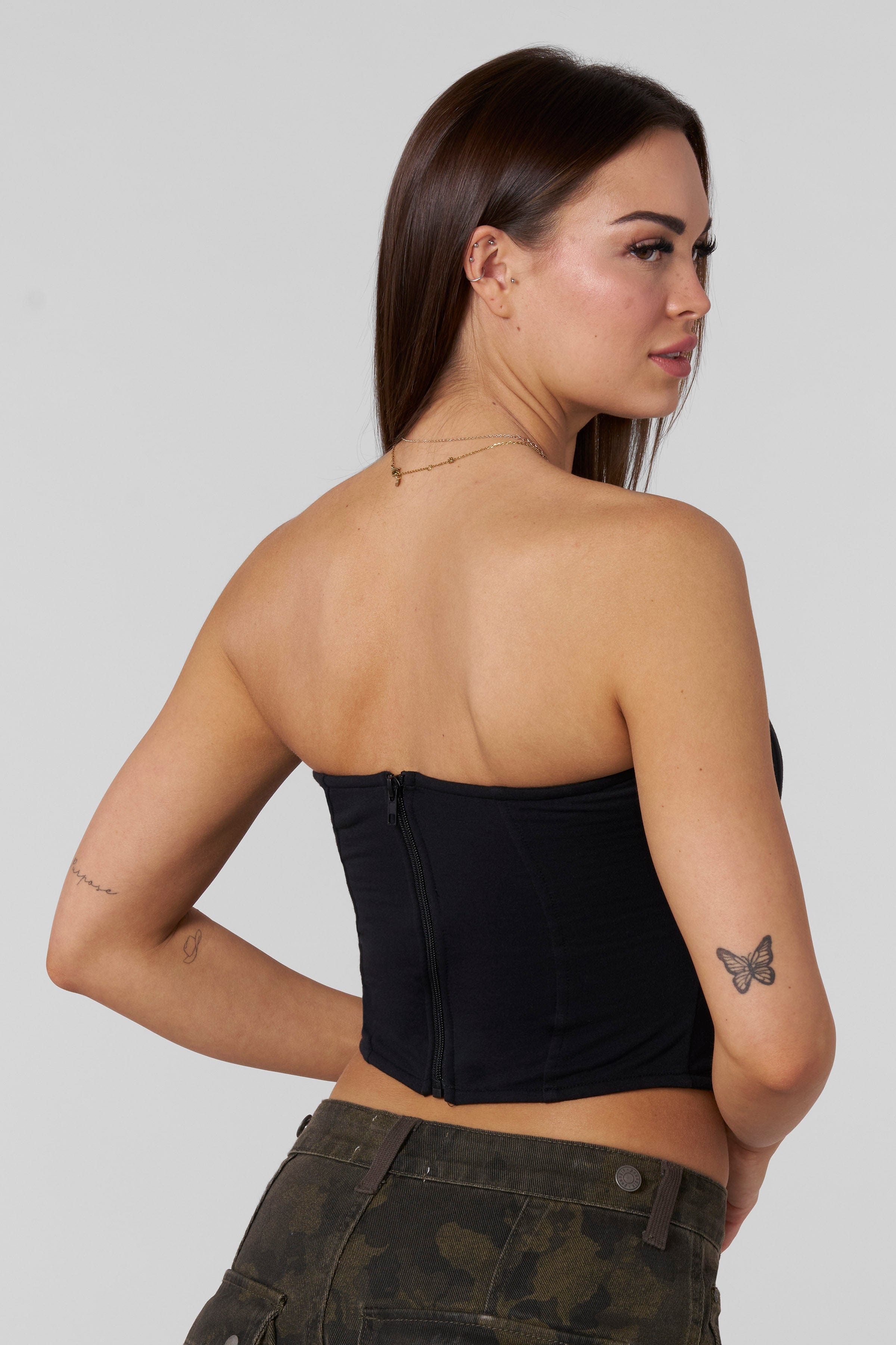 Front-view of black corset on model styled for nightwear.
